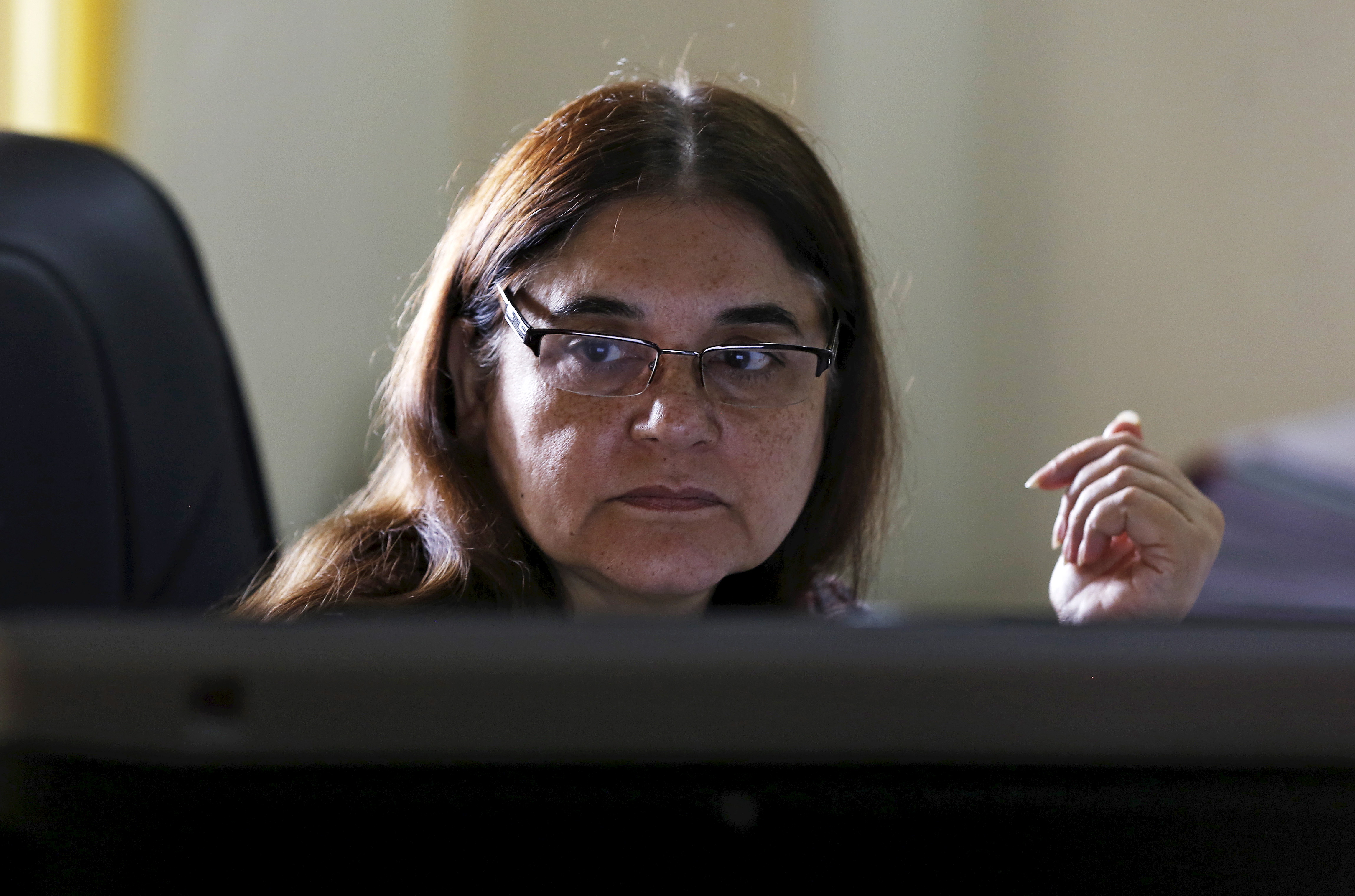 Indias Women and Child Welfare minister Gandhi works on a computer before an interview with Reuters at her office in New Delhi