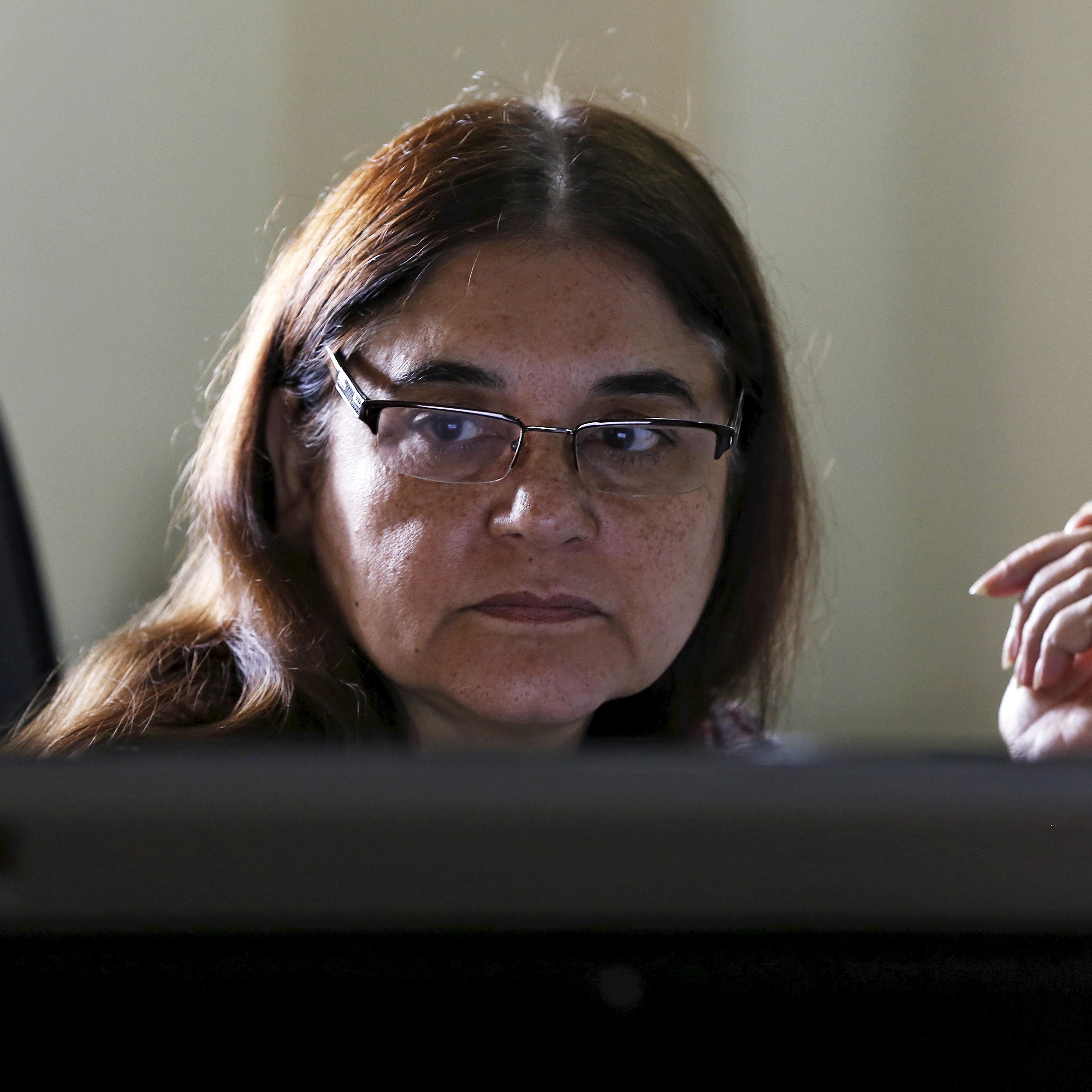 Indias Women and Child Welfare minister Gandhi works on a computer before an interview with Reuters at her office in New Delhi