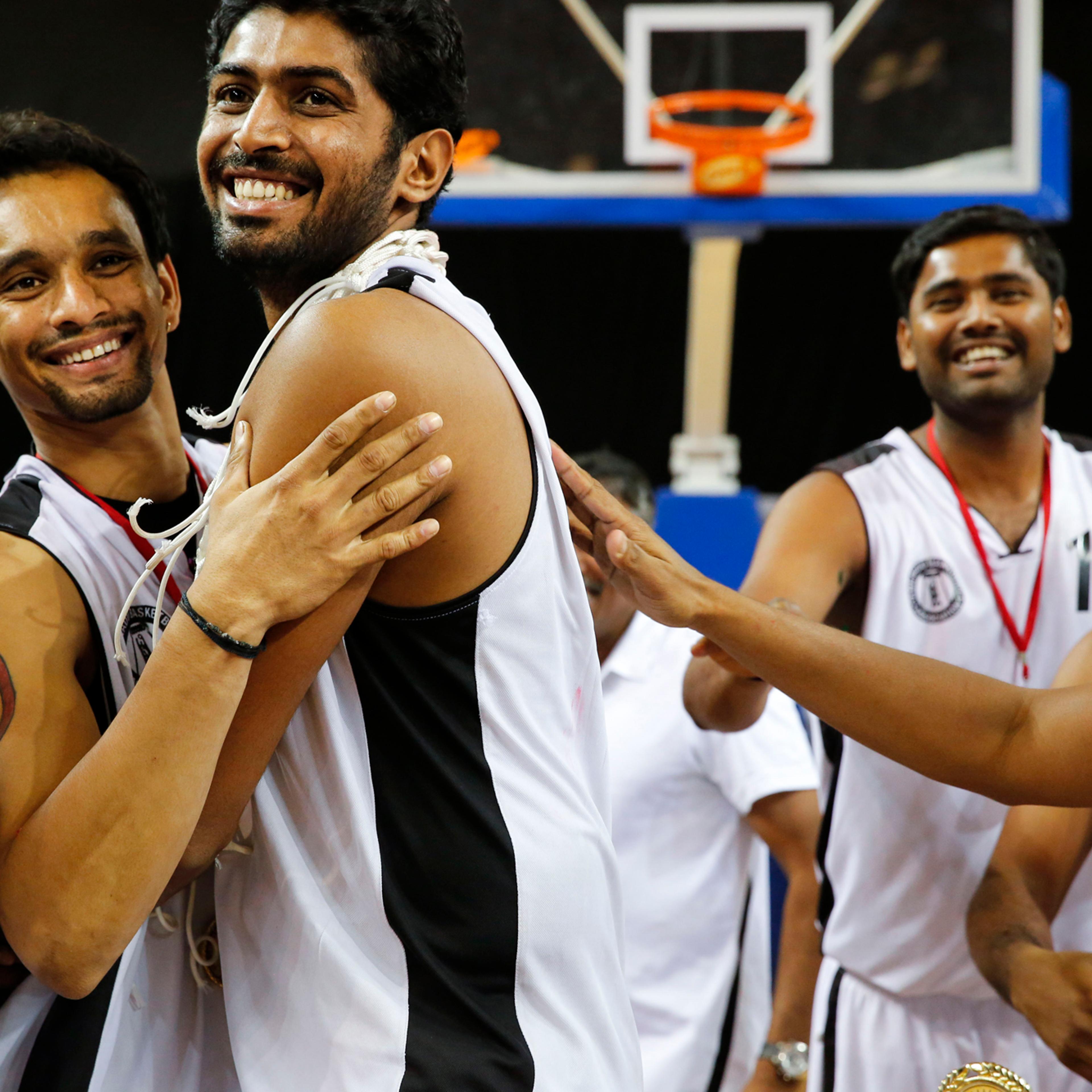 Pratham Singh, Riken Pethani, Akilan Pari and members of the Tamil Nadu team celebrate their victory at the 64th Senior National Basketball Championship for Men and Women, Delhi, 2014.