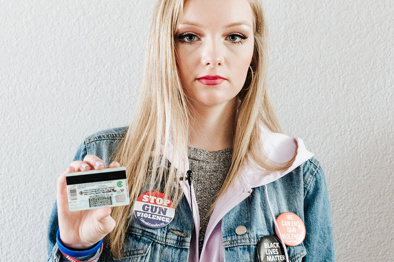 Columbine High School senior, Kaylee Tyner,17 holds the #MyLastShot sticker on the back of her ID.
