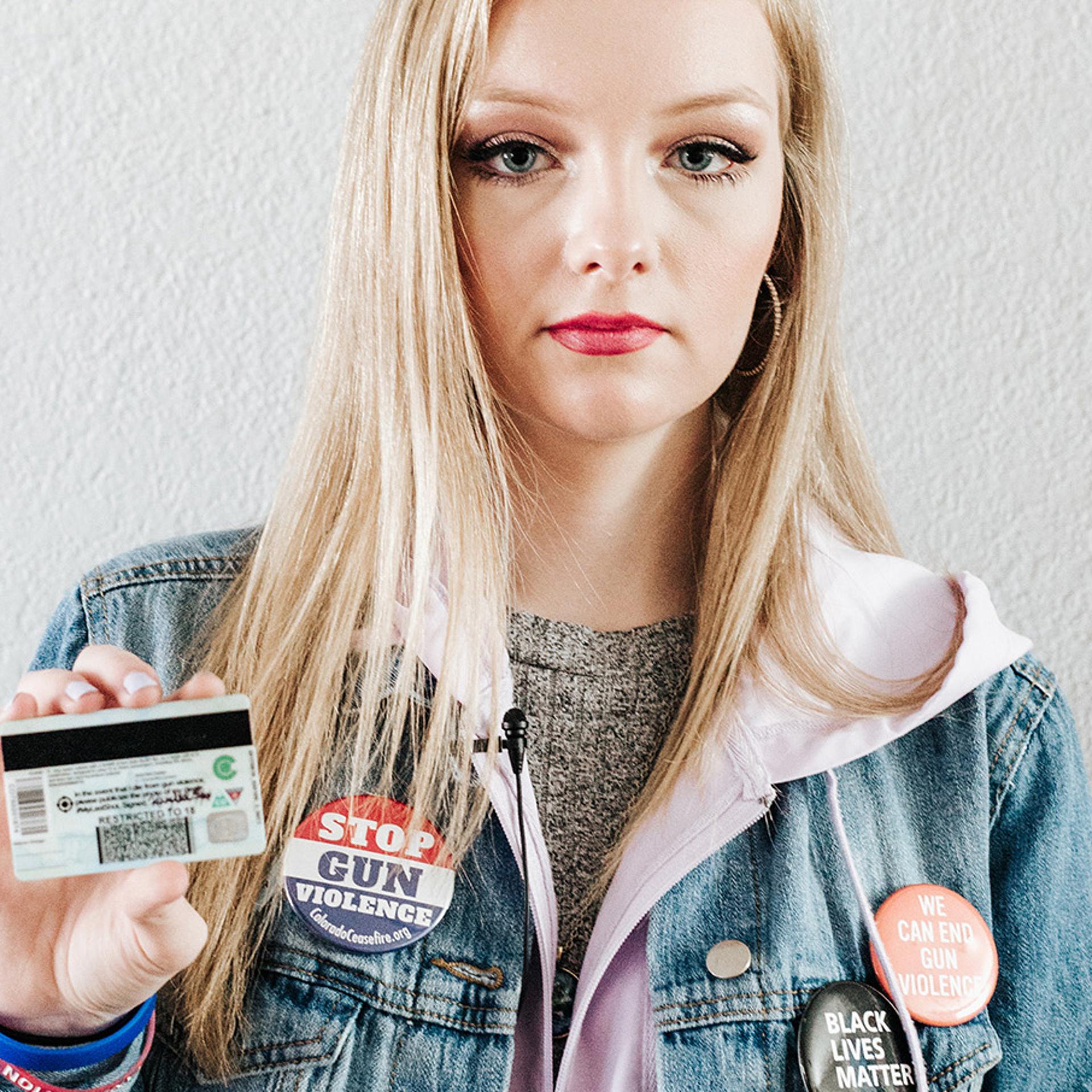 Columbine High School senior, Kaylee Tyner,17 holds the #MyLastShot sticker on the back of her ID.