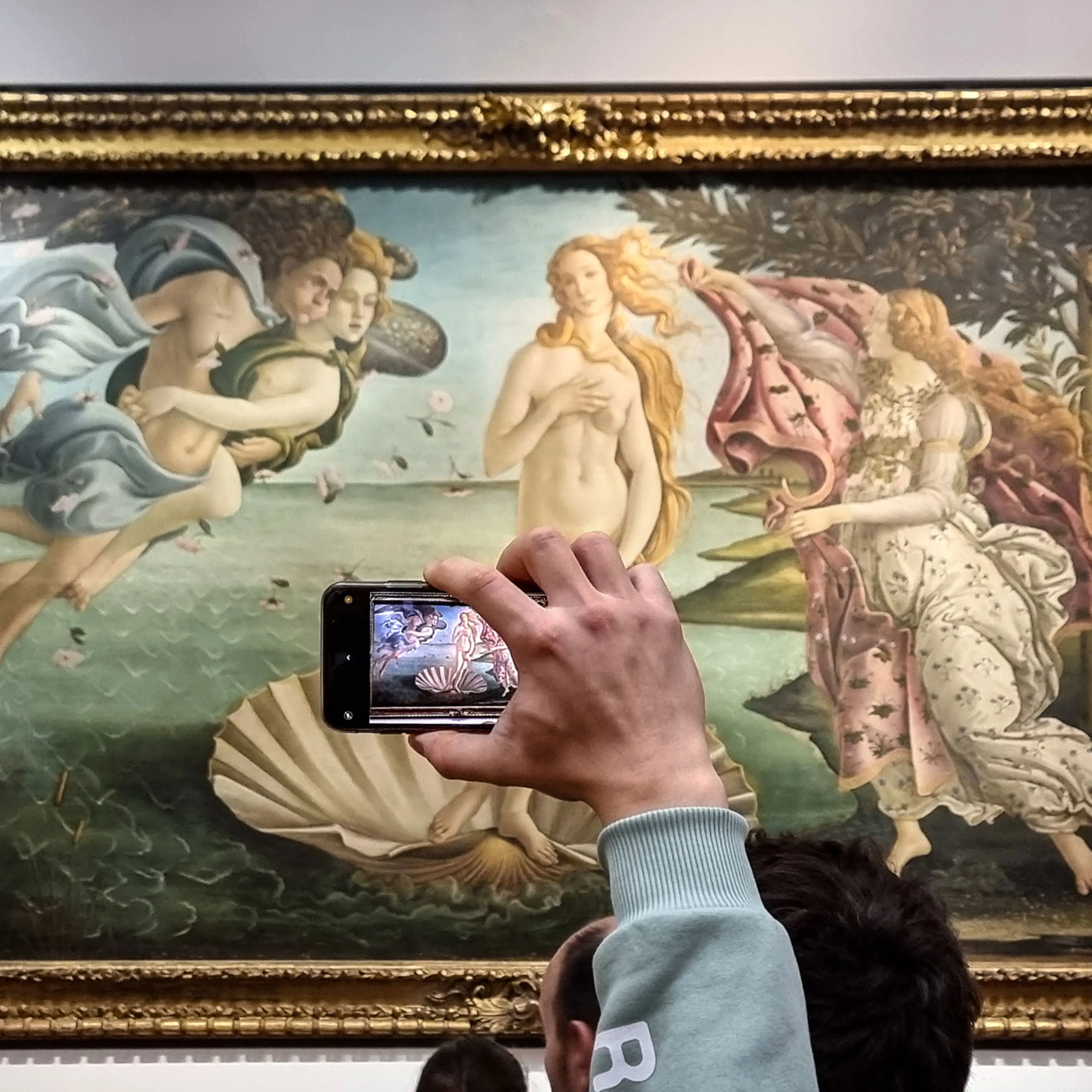 Visitors view and photograph the iconic painting The Birth of Venus (Nascita di Venere)