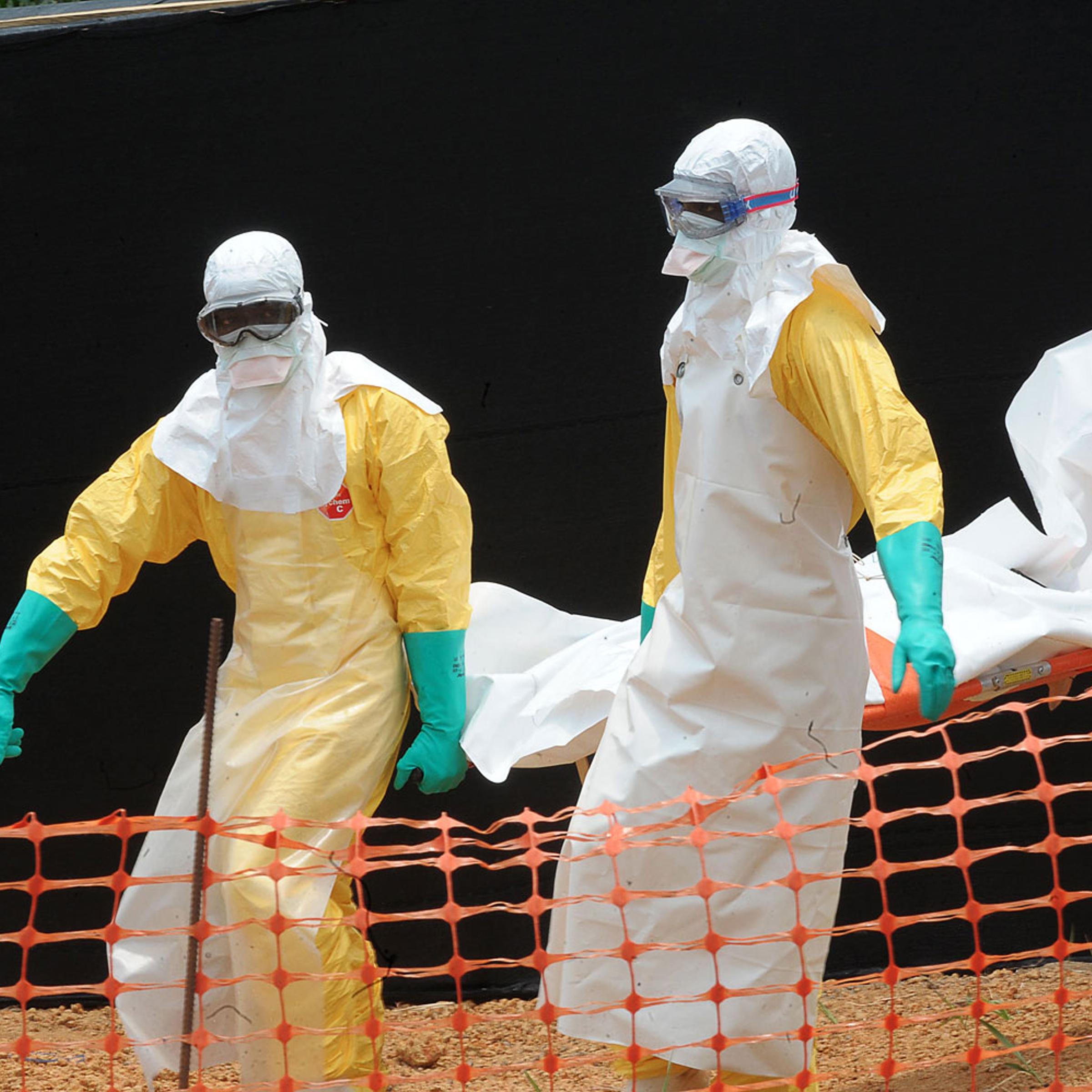 Doctors Without Borders/Médecins Sans Frontières staff carrying the body of a person killed by viral hemorrhagic fever at a center for victims of the Ebola virus in Gueckedou on April 1, 2014.