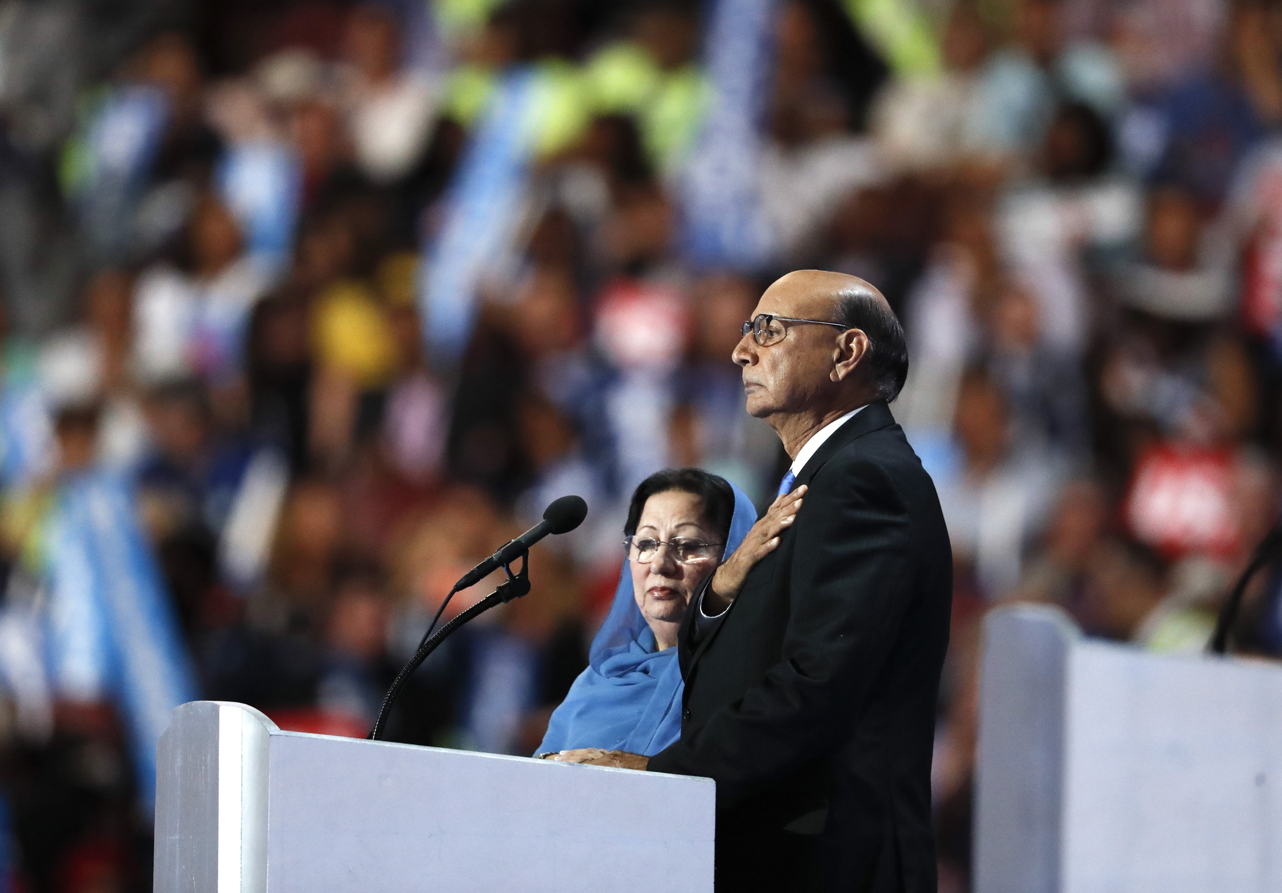 Khizr Khan, father of fallen US Army Capt. Humayun S. M. Khan, speaks while his wife Ghazala Khan looks on, during the final day of the Democratic National Convention in Philadelphia on July 28, 2016.