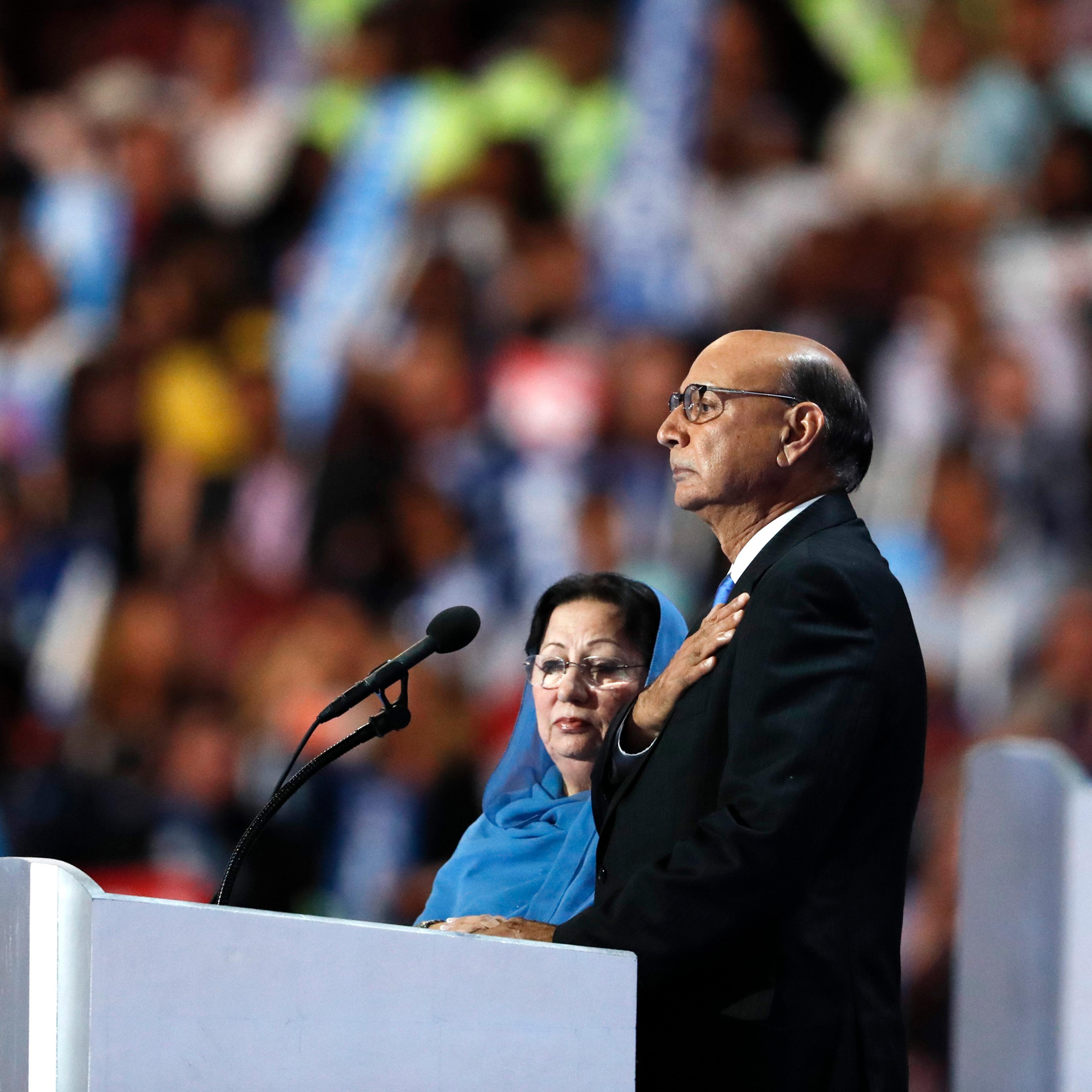 Khizr Khan, father of fallen US Army Capt. Humayun S. M. Khan, speaks while his wife Ghazala Khan looks on, during the final day of the Democratic National Convention in Philadelphia on July 28, 2016.