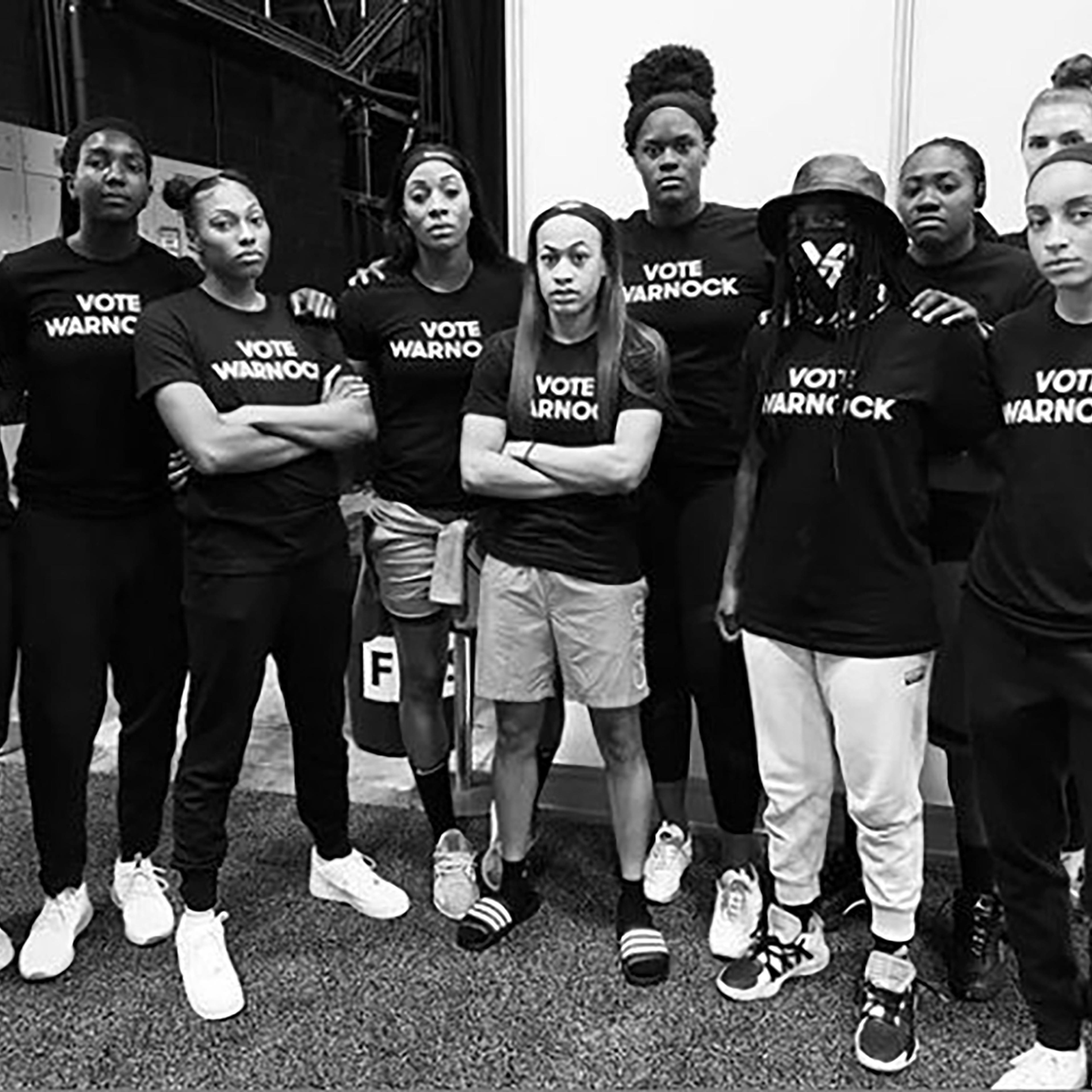 Players of the Atlanta Dream wear t-shirts that read "Vote Warnock"