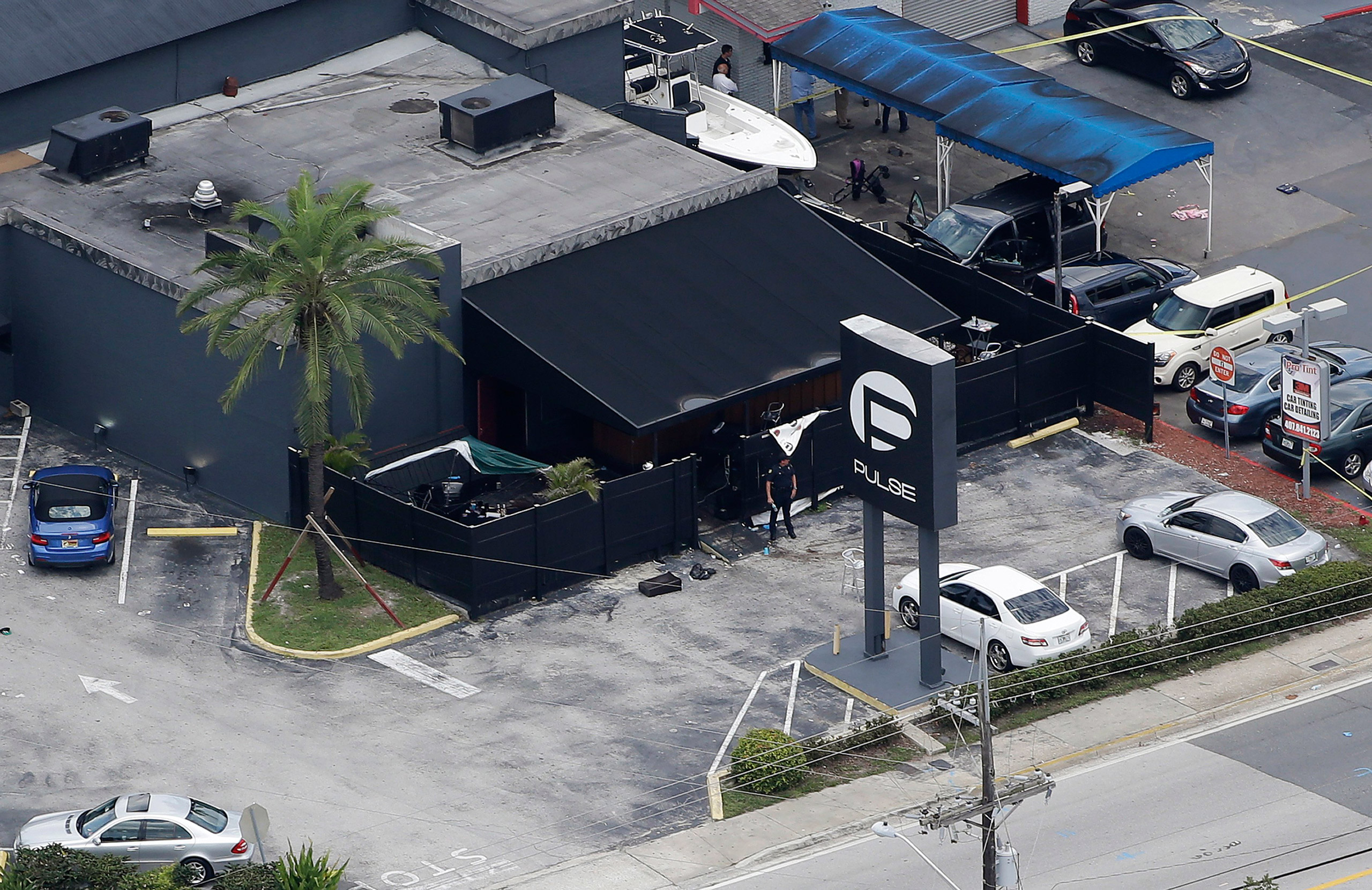 Law enforcement officials work at the Pulse Orlando nightclub following a fatal shooting Sunday, June 12, 2016, in Orlando, Fla. . (AP Photo/Chris O'Meara)