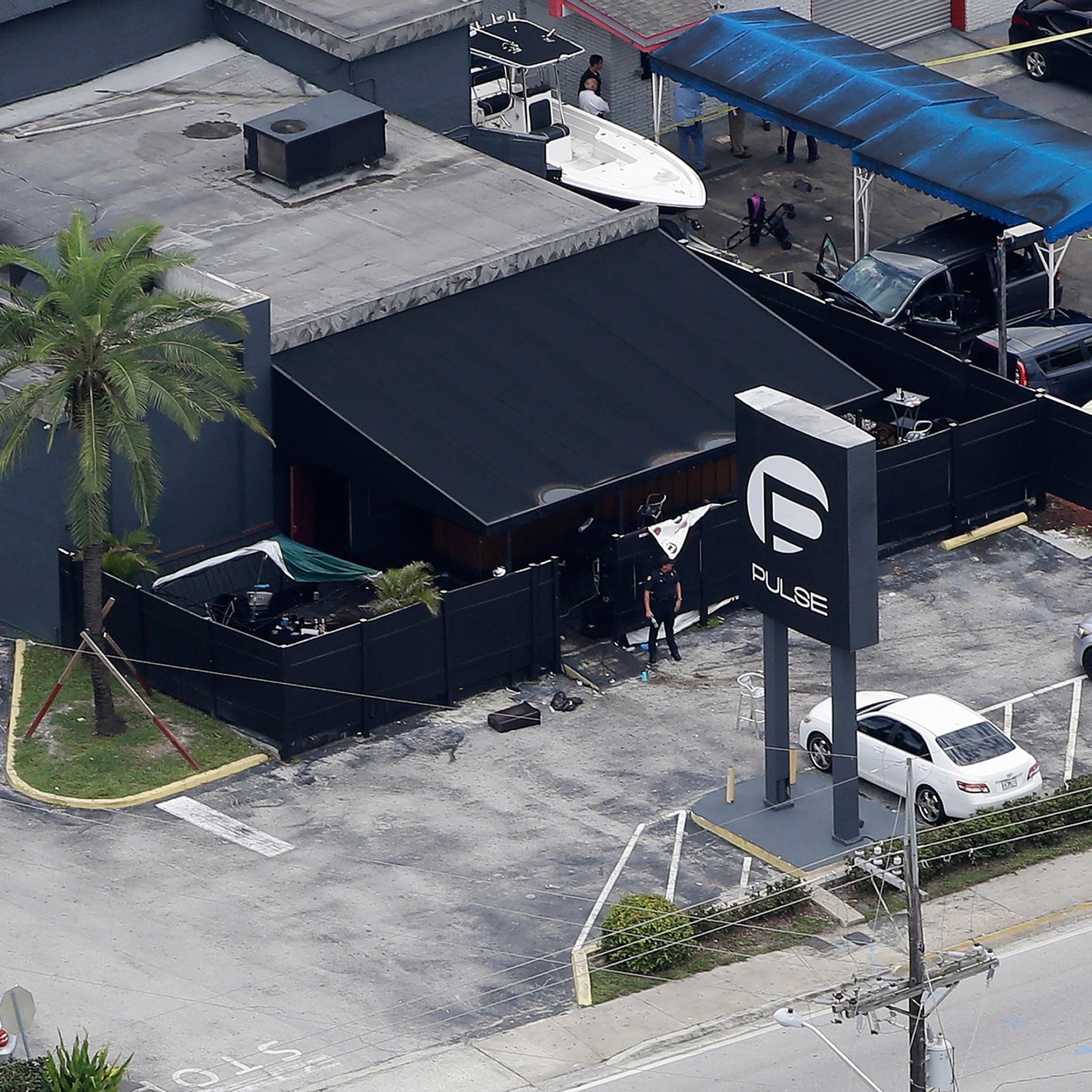 Law enforcement officials work at the Pulse Orlando nightclub following a fatal shooting Sunday, June 12, 2016, in Orlando, Fla. . (AP Photo/Chris O'Meara)