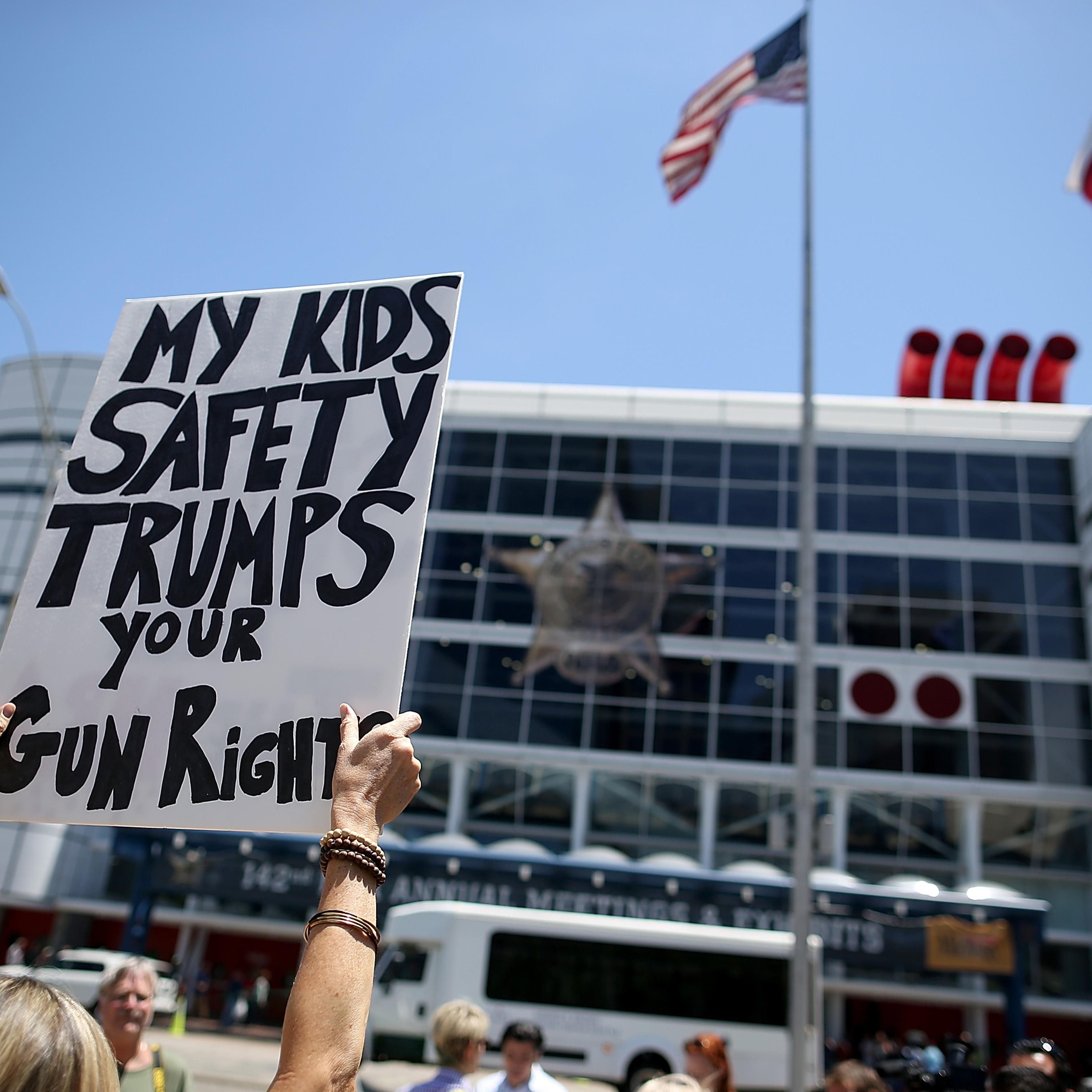 A protestor holds a sign during a demonstration in favor of gun regulation in Houston on May 4, 2013.