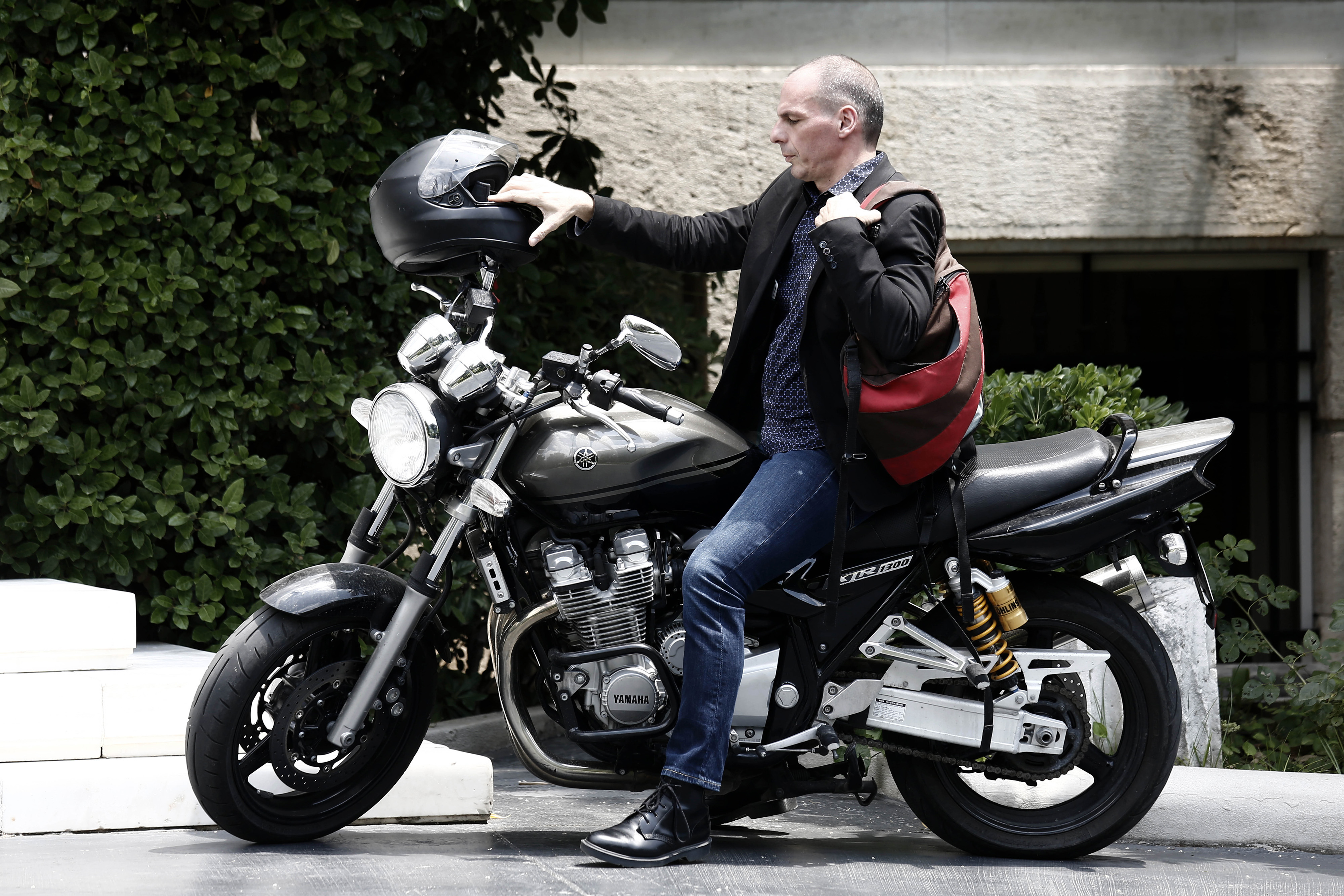 Yanis Varoufakis, Greece's finance minister, arrives on a motorbike for a government meeting at Maximos Mansion in Athens, Greece, on Sunday, June 28, 2015. Greek bank executives and European officials are warning of an imminent cash crunch or bank shutd