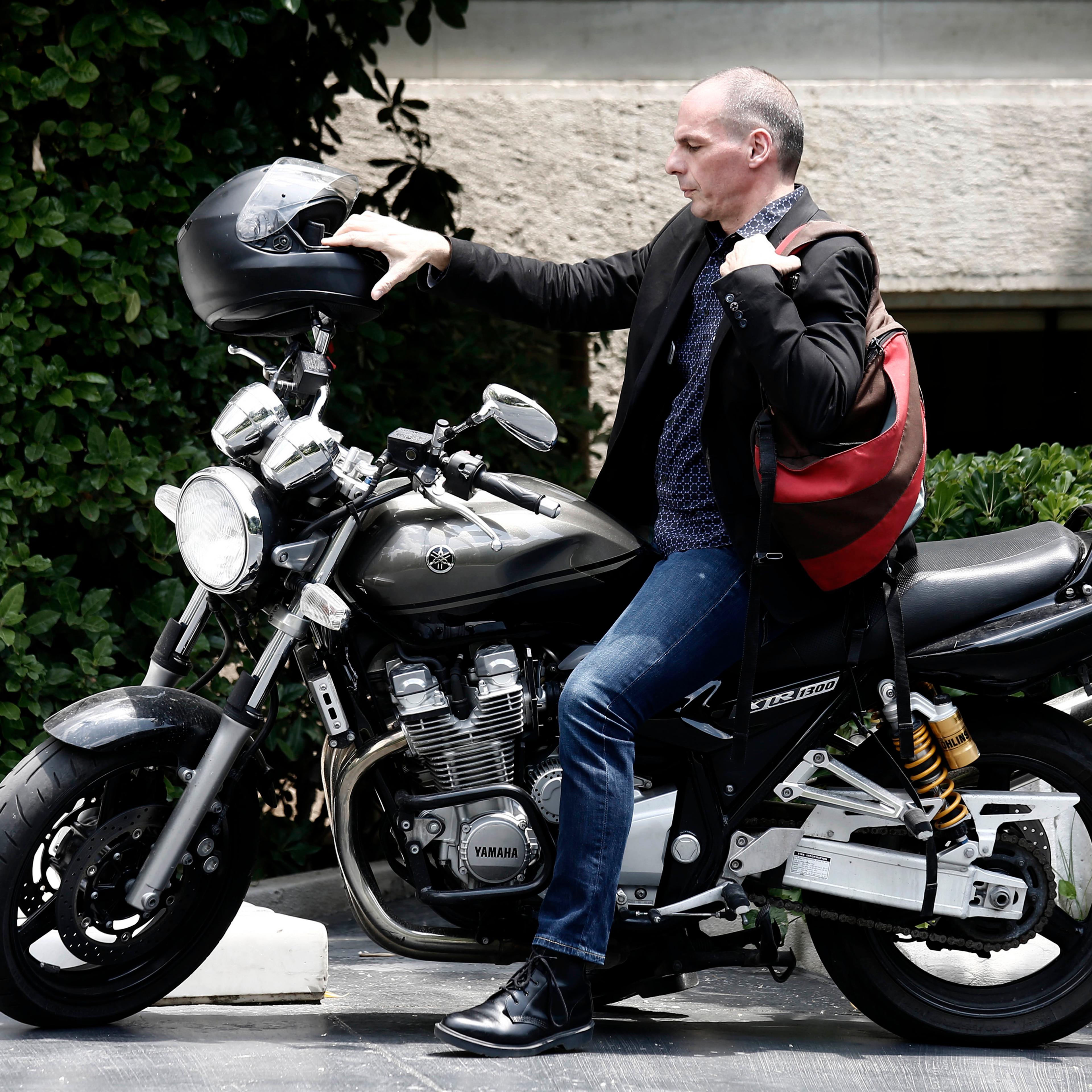 Yanis Varoufakis, Greece's finance minister, arrives on a motorbike for a government meeting at Maximos Mansion in Athens, Greece, on Sunday, June 28, 2015. Greek bank executives and European officials are warning of an imminent cash crunch or bank shutd