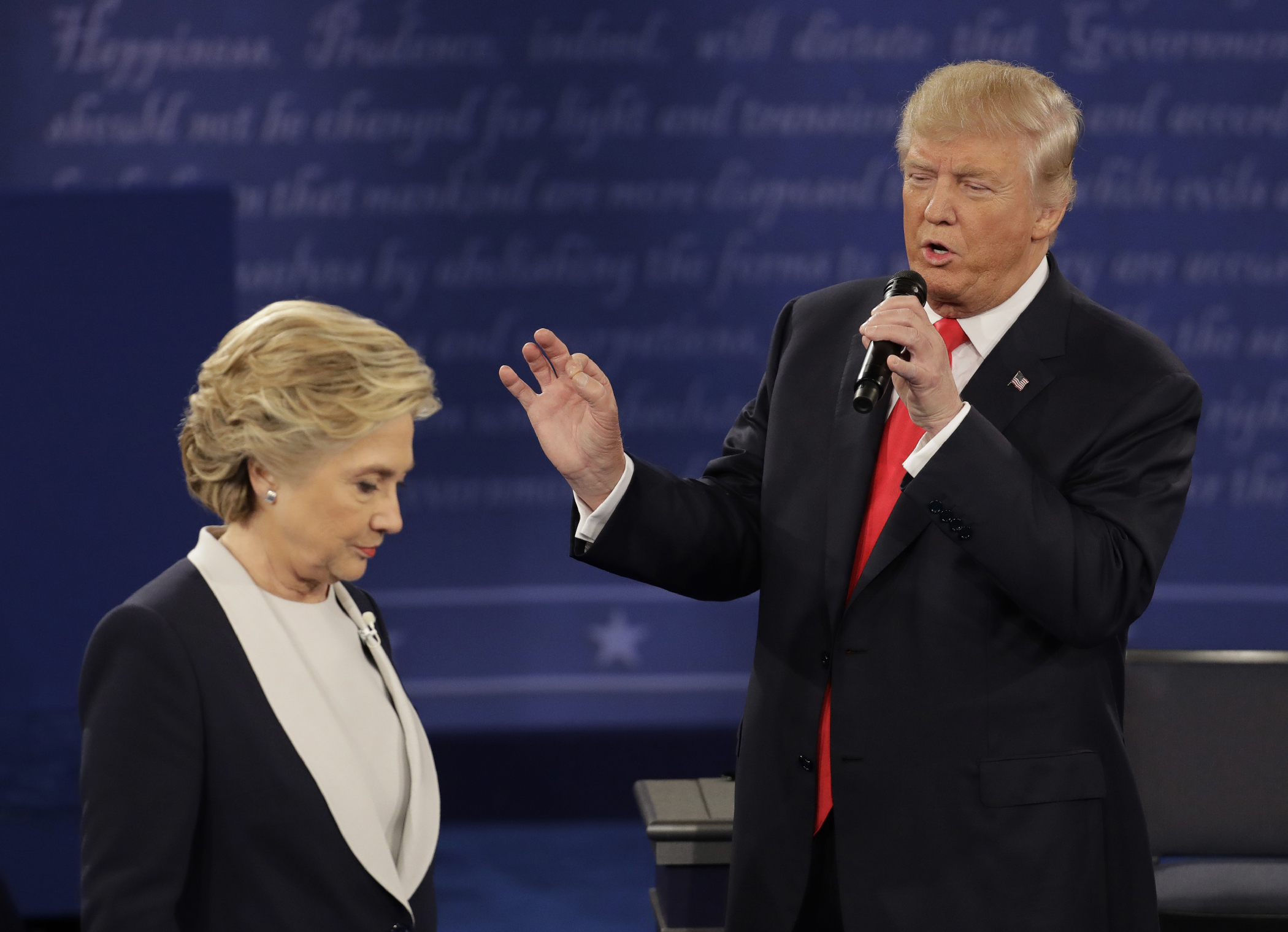 Democratic presidential nominee Hillary Clinton walks past Republican presidential nominee Donald Trump during the second presidential debate at Washington University in St. Louis, Sunday, Oct. 9, 2016.
