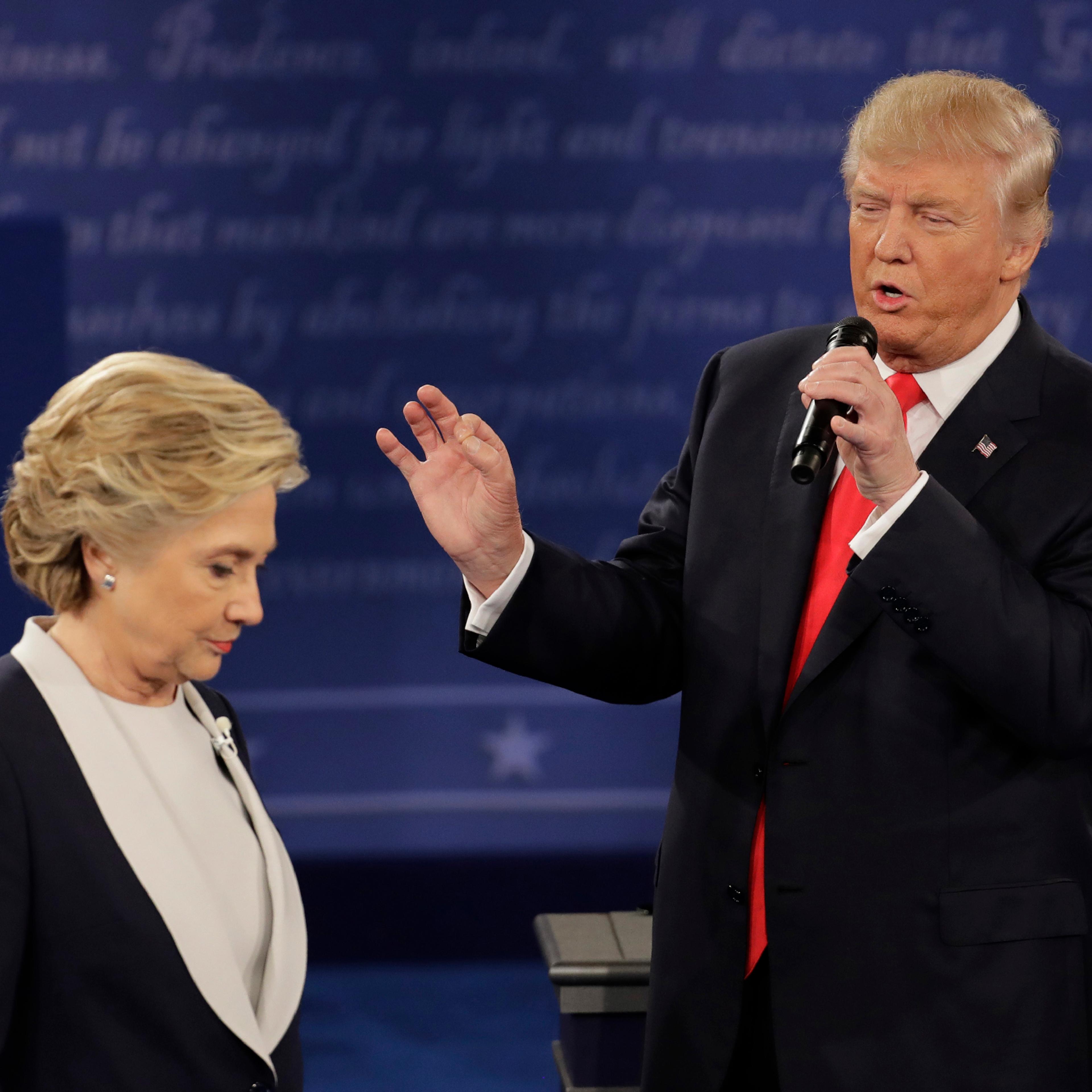 Democratic presidential nominee Hillary Clinton walks past Republican presidential nominee Donald Trump during the second presidential debate at Washington University in St. Louis, Sunday, Oct. 9, 2016.