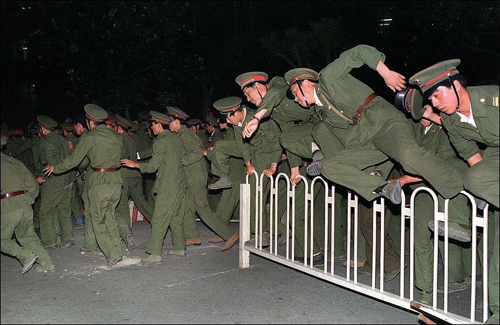 People Liberation Army (PLA) soldiers leap over a