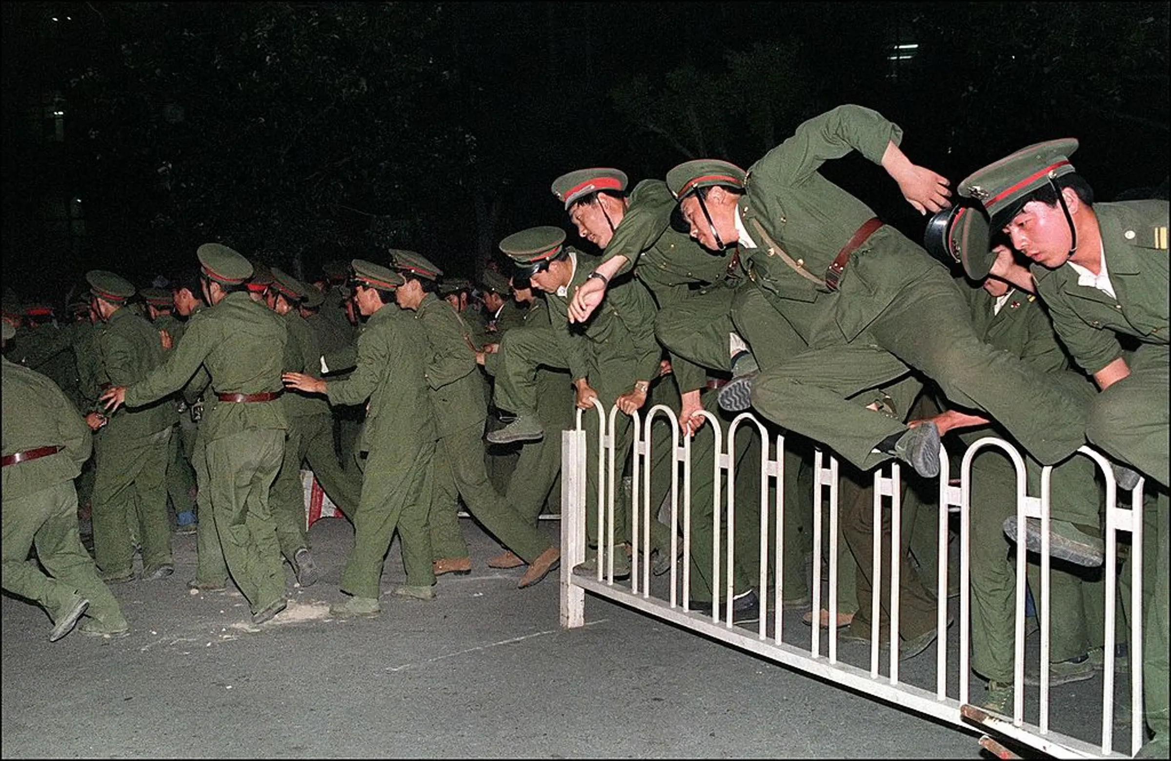 People Liberation Army (PLA) soldiers leap over a