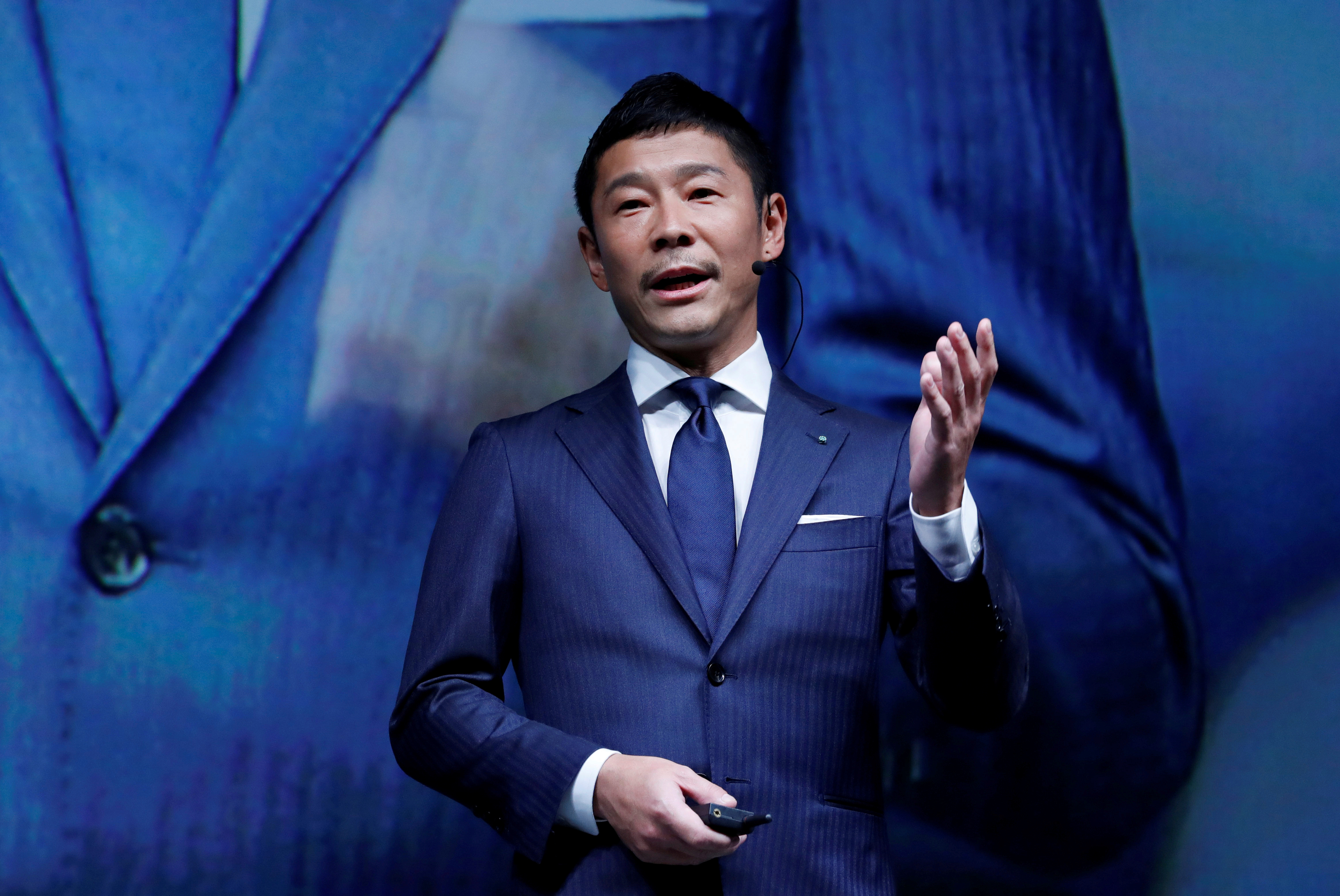 FILE PHOTO: Maezawa, the chief executive of Zozo, which operates Japan's popular fashion shopping site Zozotown and is officially called Start Today Co, speaks at an event launching the debut of its formal apparel items, in Tokyo