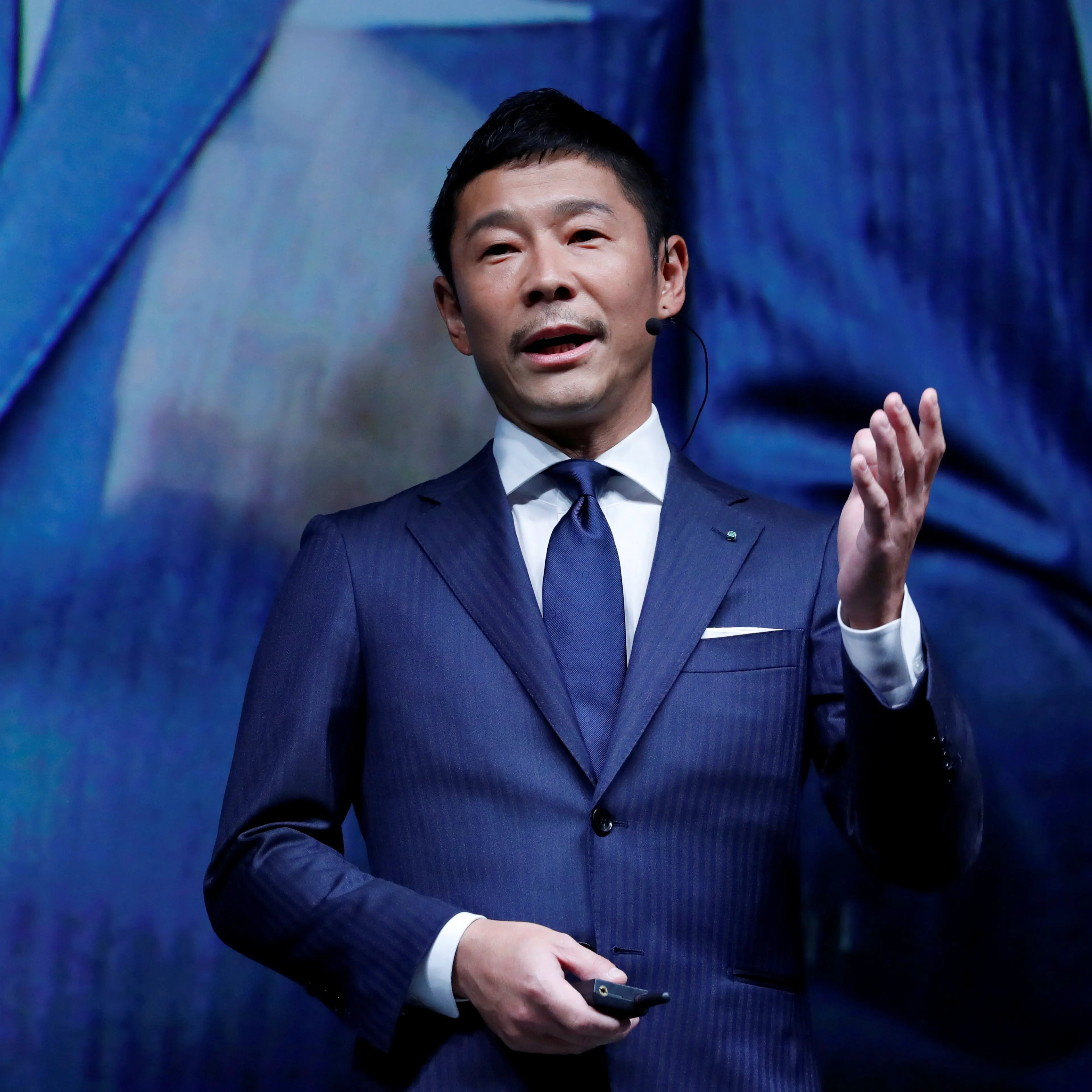 FILE PHOTO: Maezawa, the chief executive of Zozo, which operates Japan's popular fashion shopping site Zozotown and is officially called Start Today Co, speaks at an event launching the debut of its formal apparel items, in Tokyo