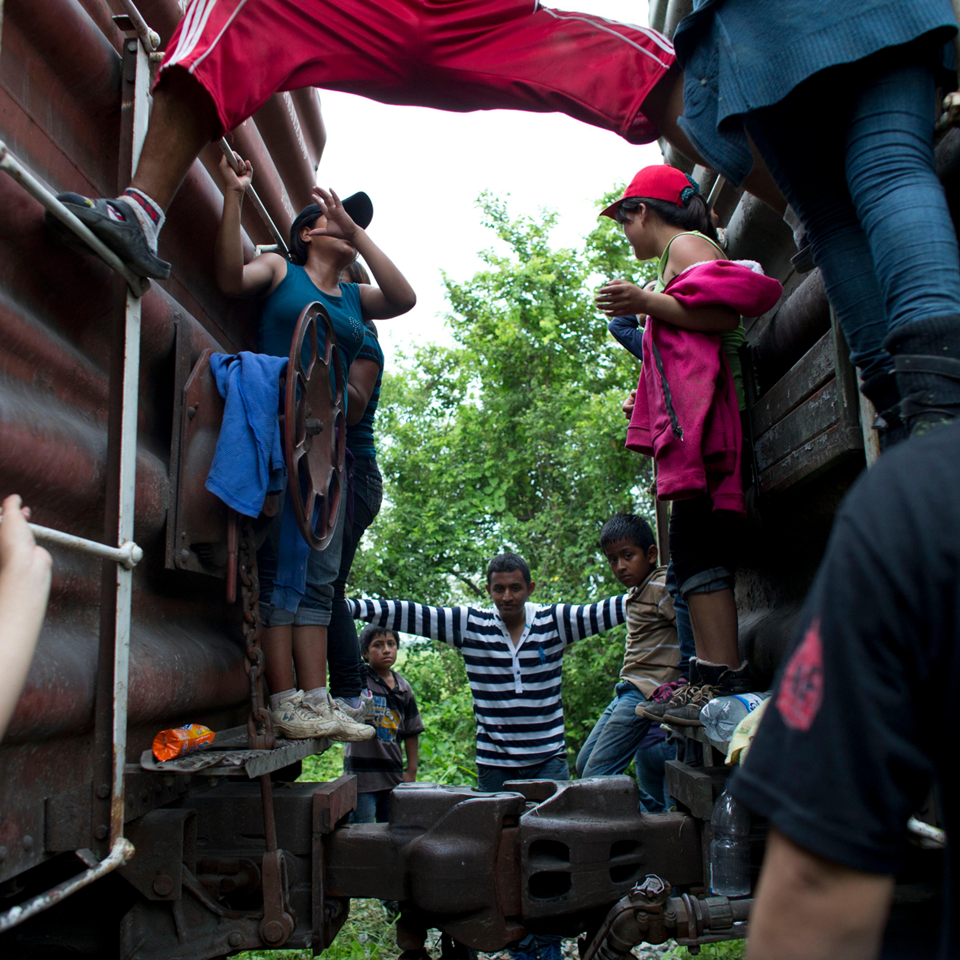 Central American migrants hang out around the northbound freight train they had been traveling on, after it suffered a minor derailment in a remote wooded area outside Reforma de Pineda, Chiapas state, Mexico, June 20.