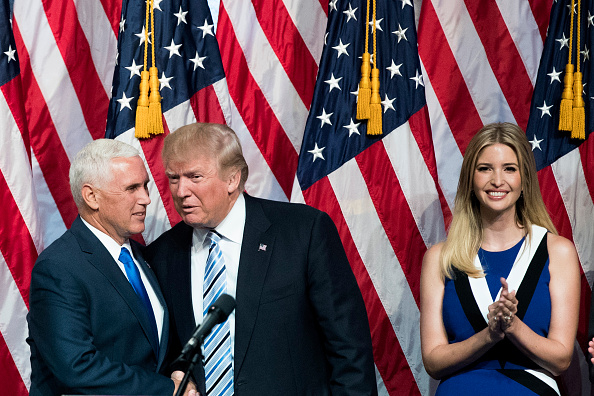 Newly selected vice presidential running mate Mike Pence, governor of Indiana, stands with Republican presidential candidate Donald Trump as Ivanka Trump looks on during an event at the Hilton Midtown Hotel, July 16, 2016 in New York City.