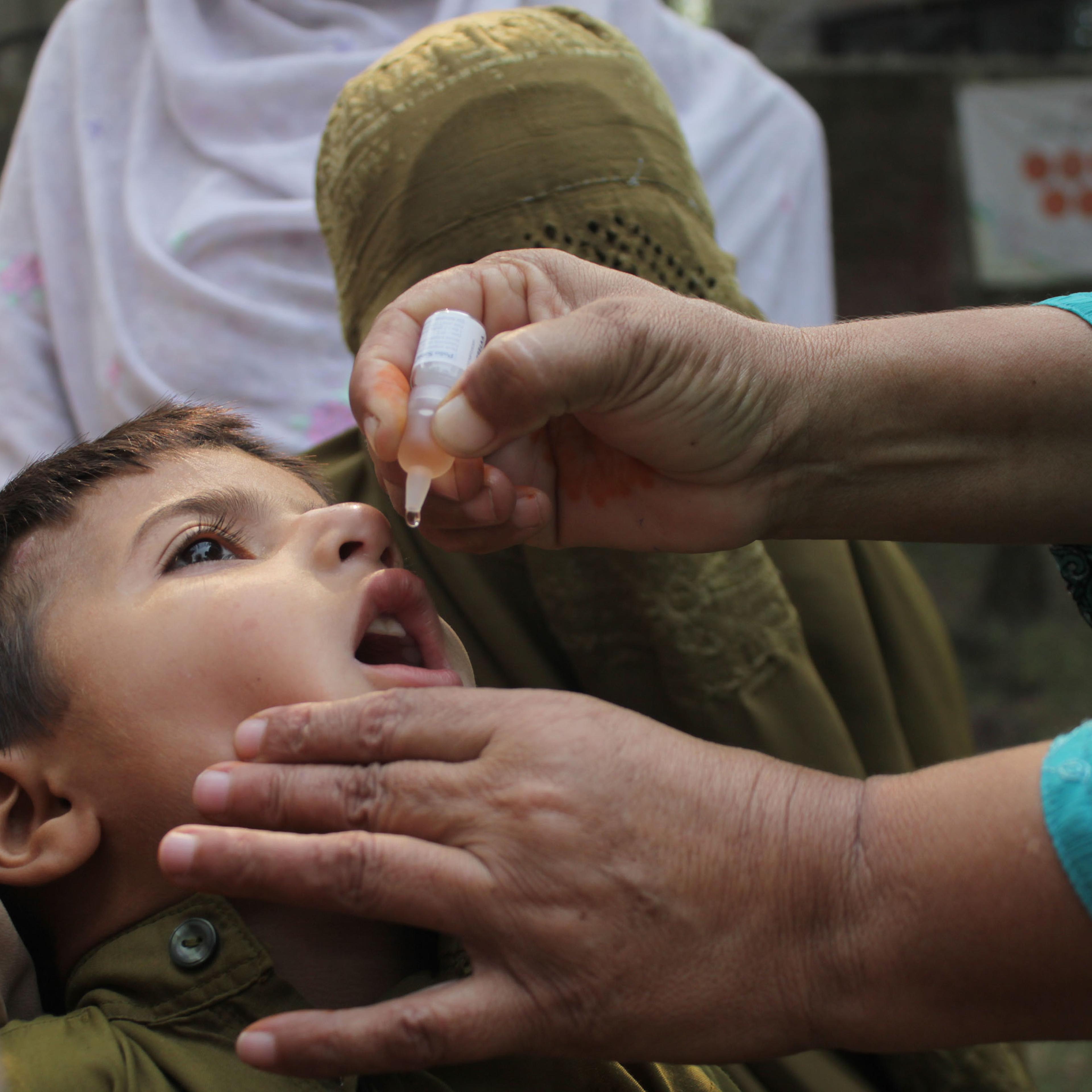 All good now: A child in Lahore, Pakistan receives the polio vaccine in 2014
