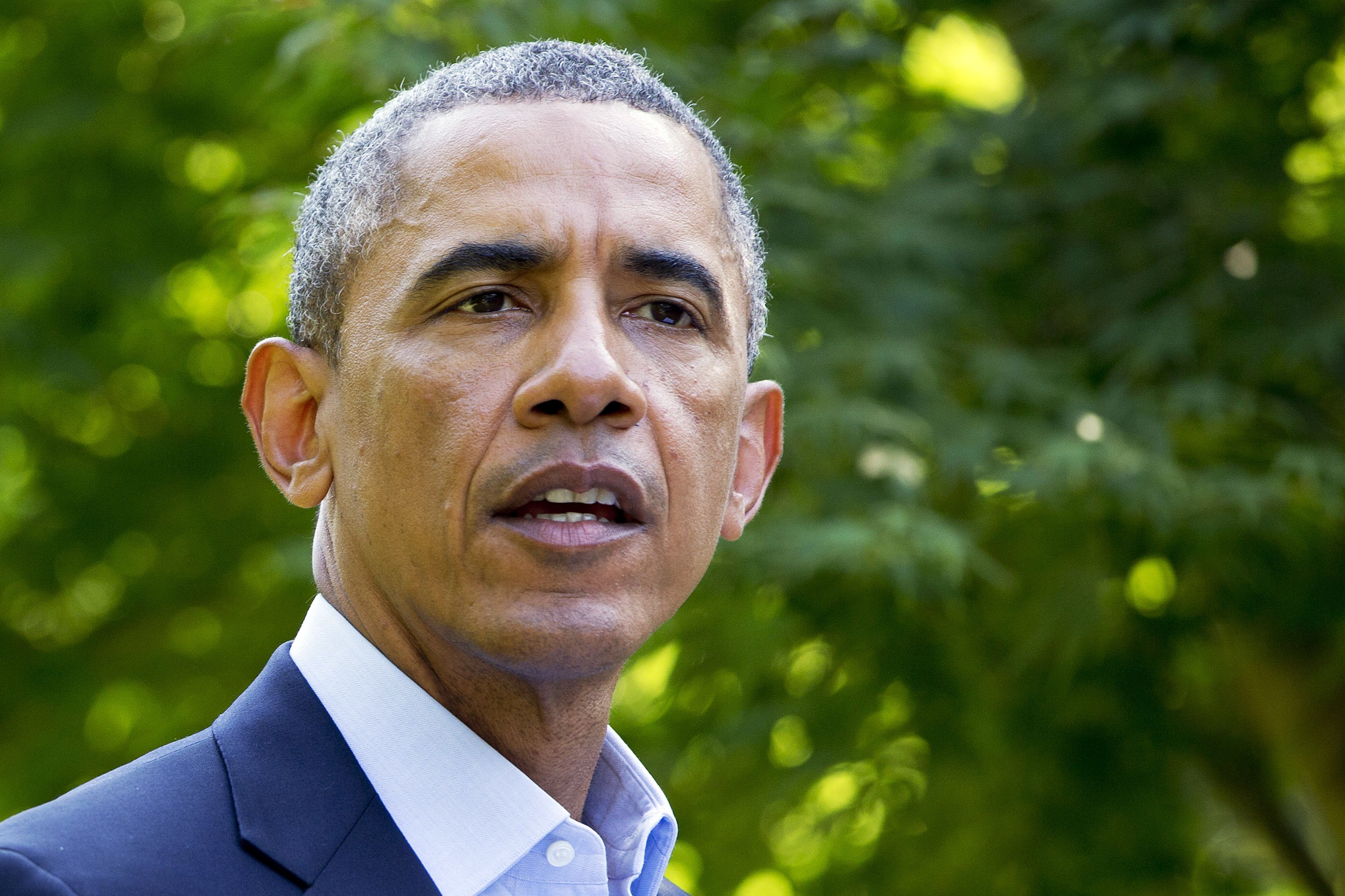 President Barack Obama speaks on Aug. 11, 2014, in Chilmark, Mass., during his family vacation on the island of Martha's Vineyard.