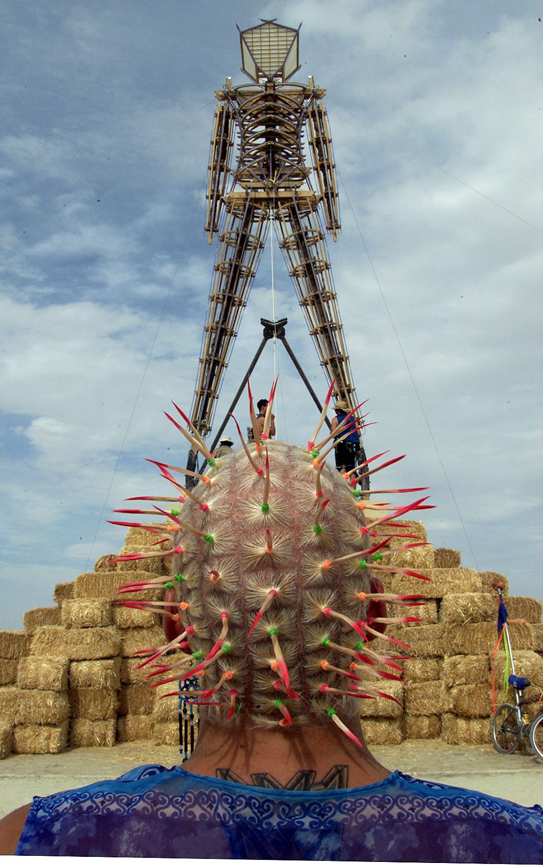 A man looks at the Burning Man effigy as it is prepared for the Burning Man Festival at Black Rock City in Nevada on Aug. 29, 2000.