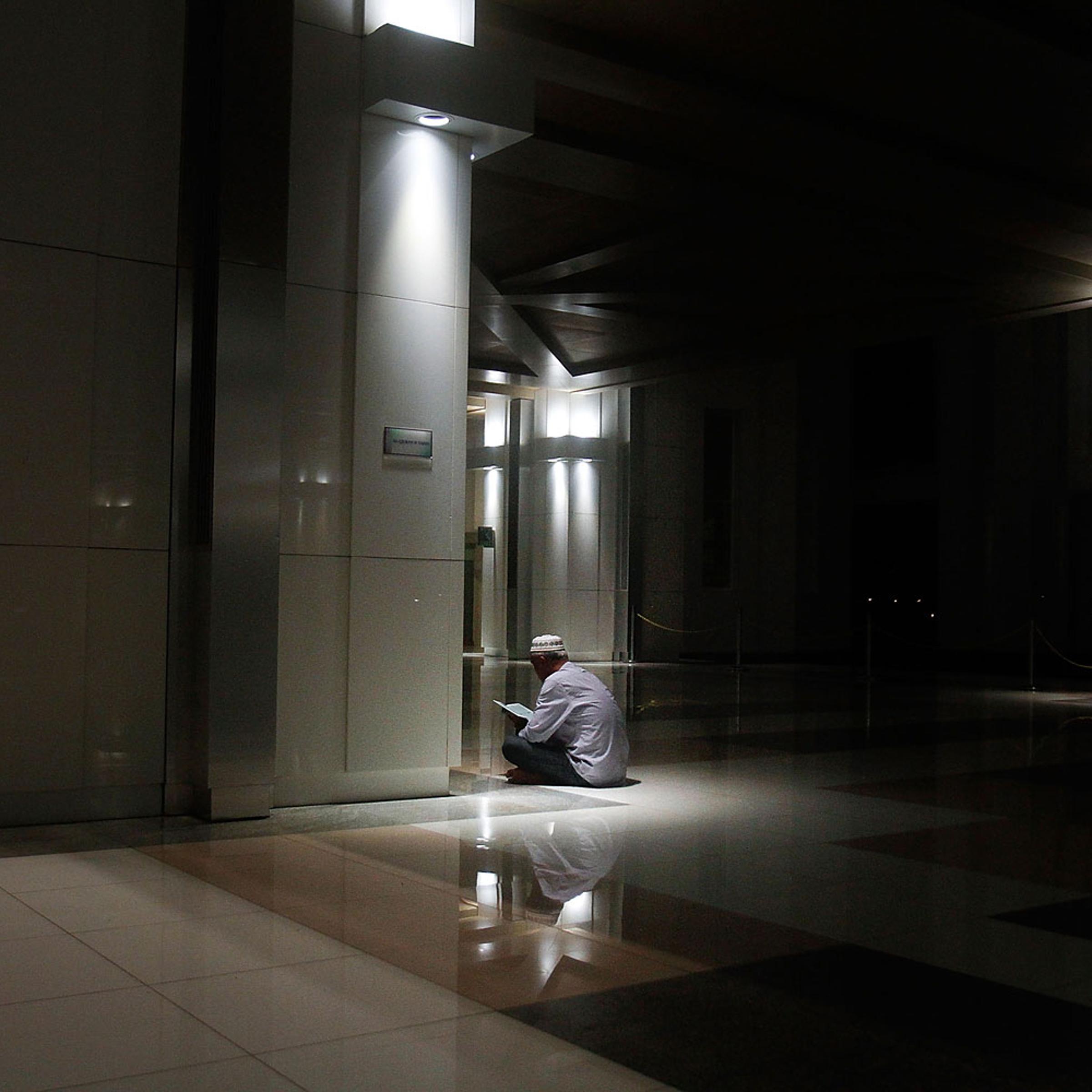 A man recites the Koran after a special prayers held for the missing Malaysian airliner MH370, March 18, 2014 in Kuala Lumpur.