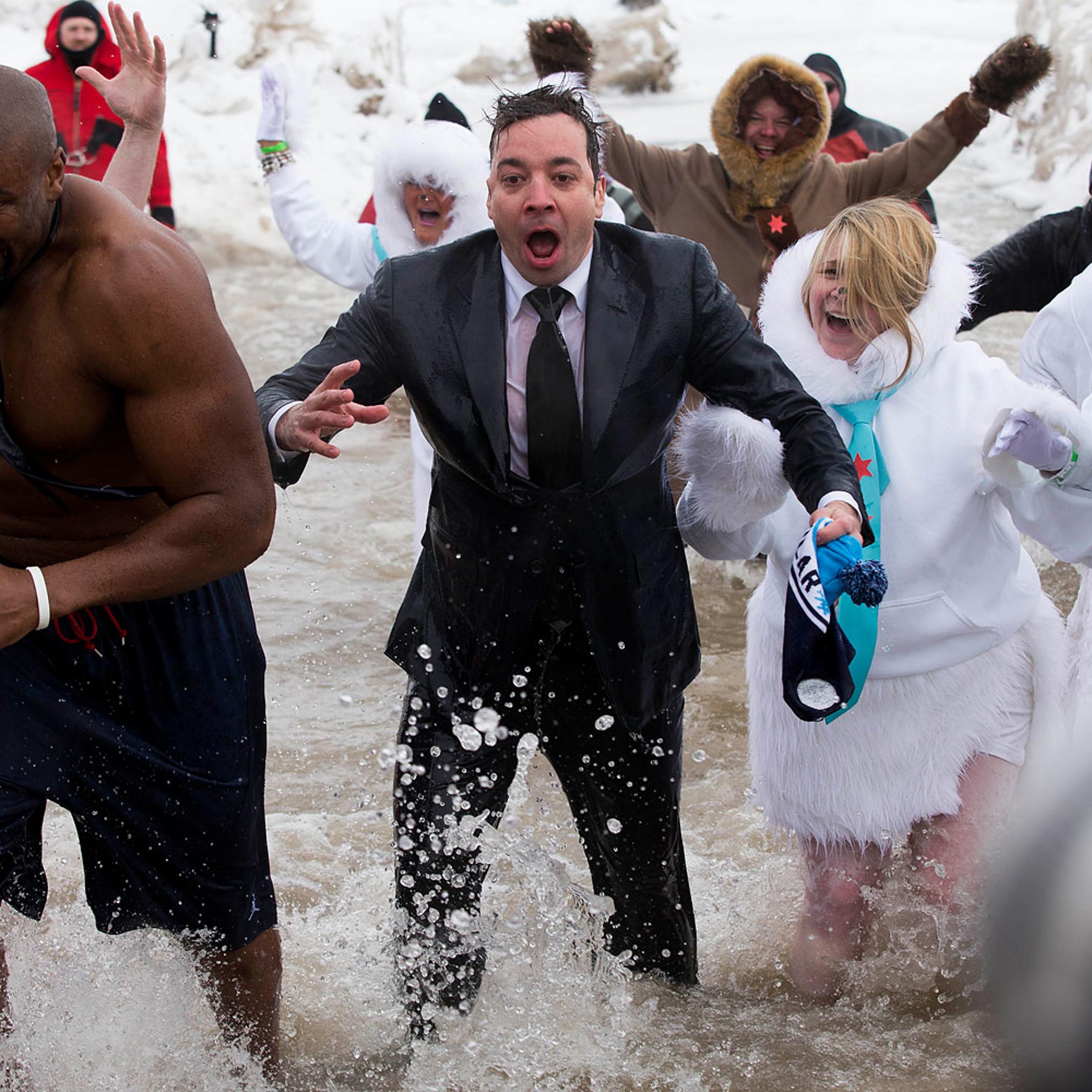 "The Tonight Show" host Jimmy Fallon, center, exits the water during the Chicago Polar Plunge, Sunday, March 2, 2014, in Chicago. Fallon joined Chicago Mayor Rahm Emanuel in the event.
