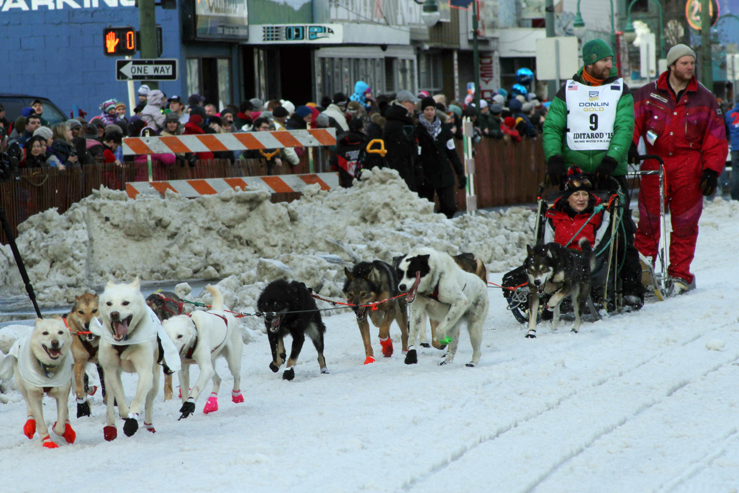 Musher Kelly Maixner, of Big Lake, Alaska, and an auction winner who rode in his sled, during the ceremonial start of the Iditarod Trail Sled Dog Race in Anchorage, Alaska, on March 7, 2015. 