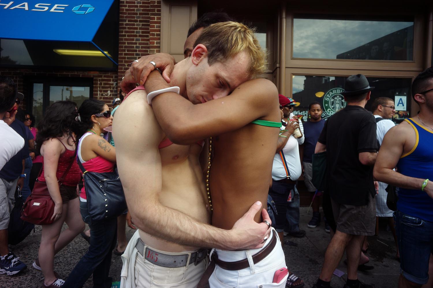 Onlookers at Gay Pride Parade in New York City embrace, June 26, 2011.