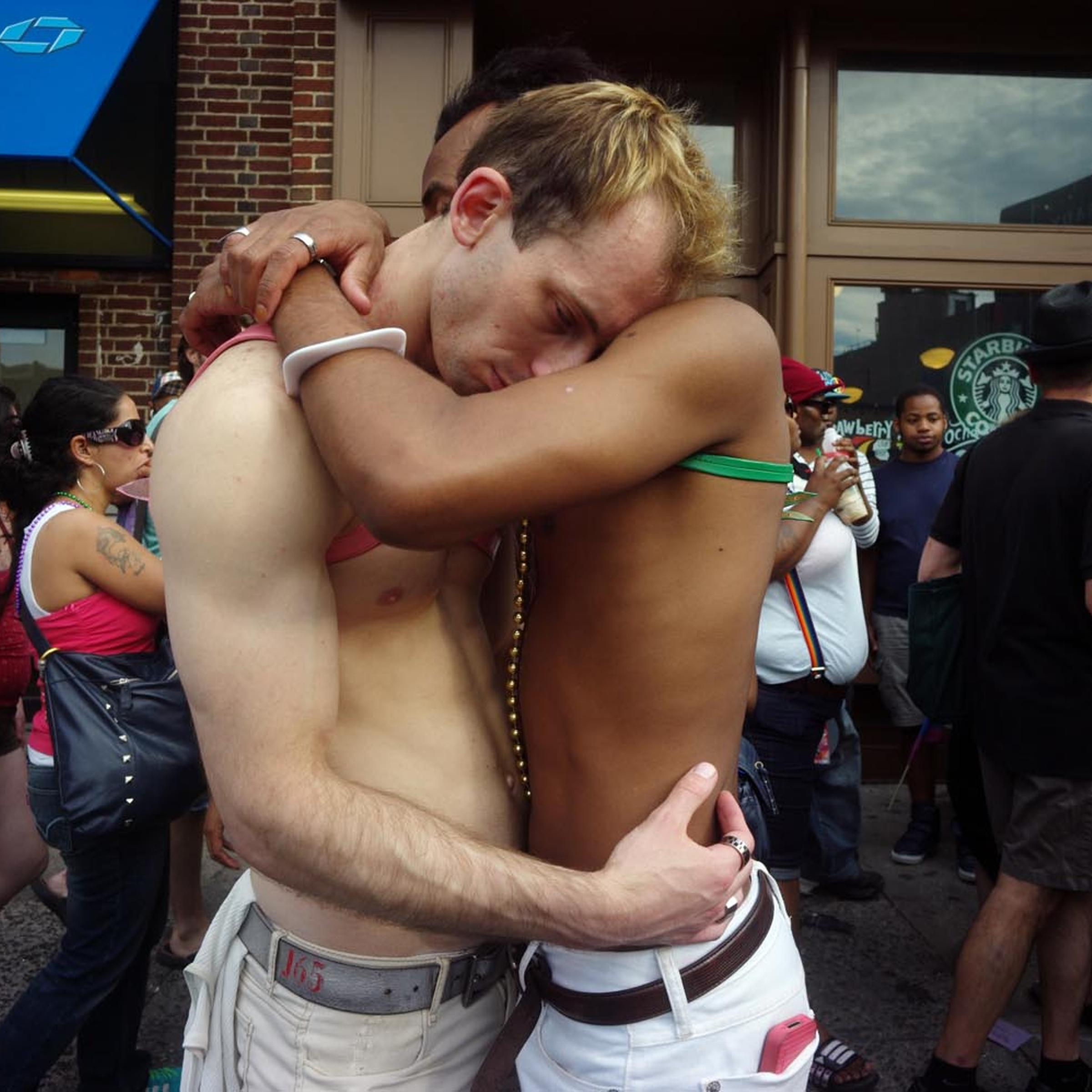 Onlookers at Gay Pride Parade in New York City embrace, June 26, 2011.