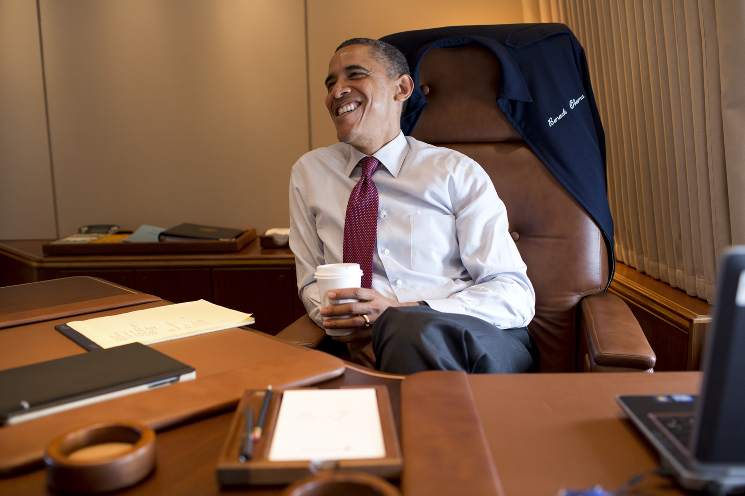 President Obama works in his private office aboard Air Force One.