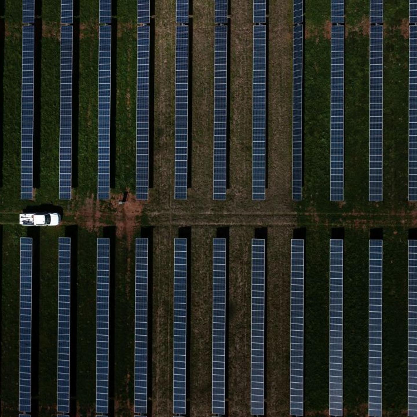 A vehicle drives through a solar farm in Plains, Georgia, on Feb. 22, 2023.