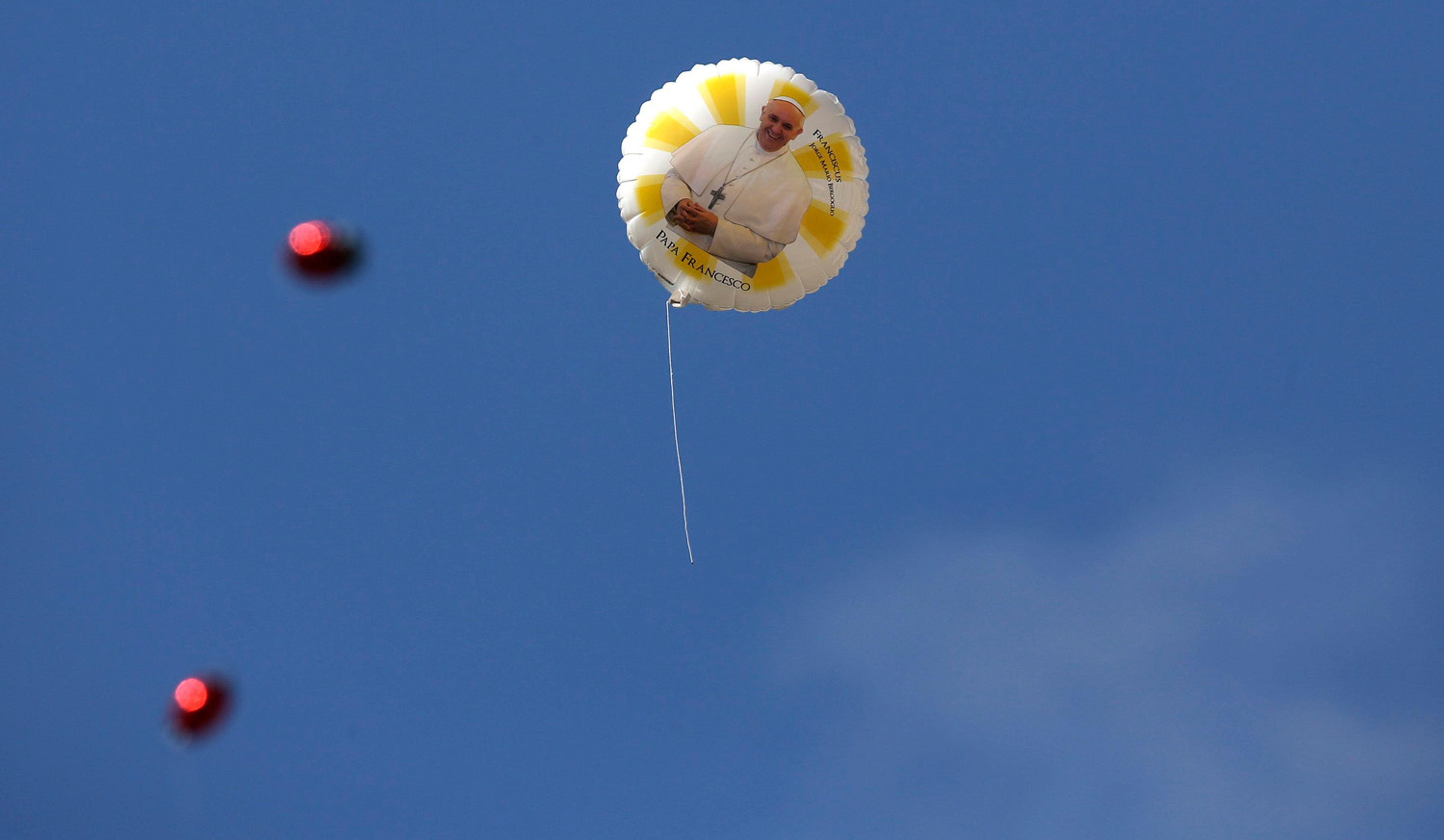 A balloon with an image of Pope Francis flies during a weekly general audience leads by the pope at St. Peter's Square at the Vatican