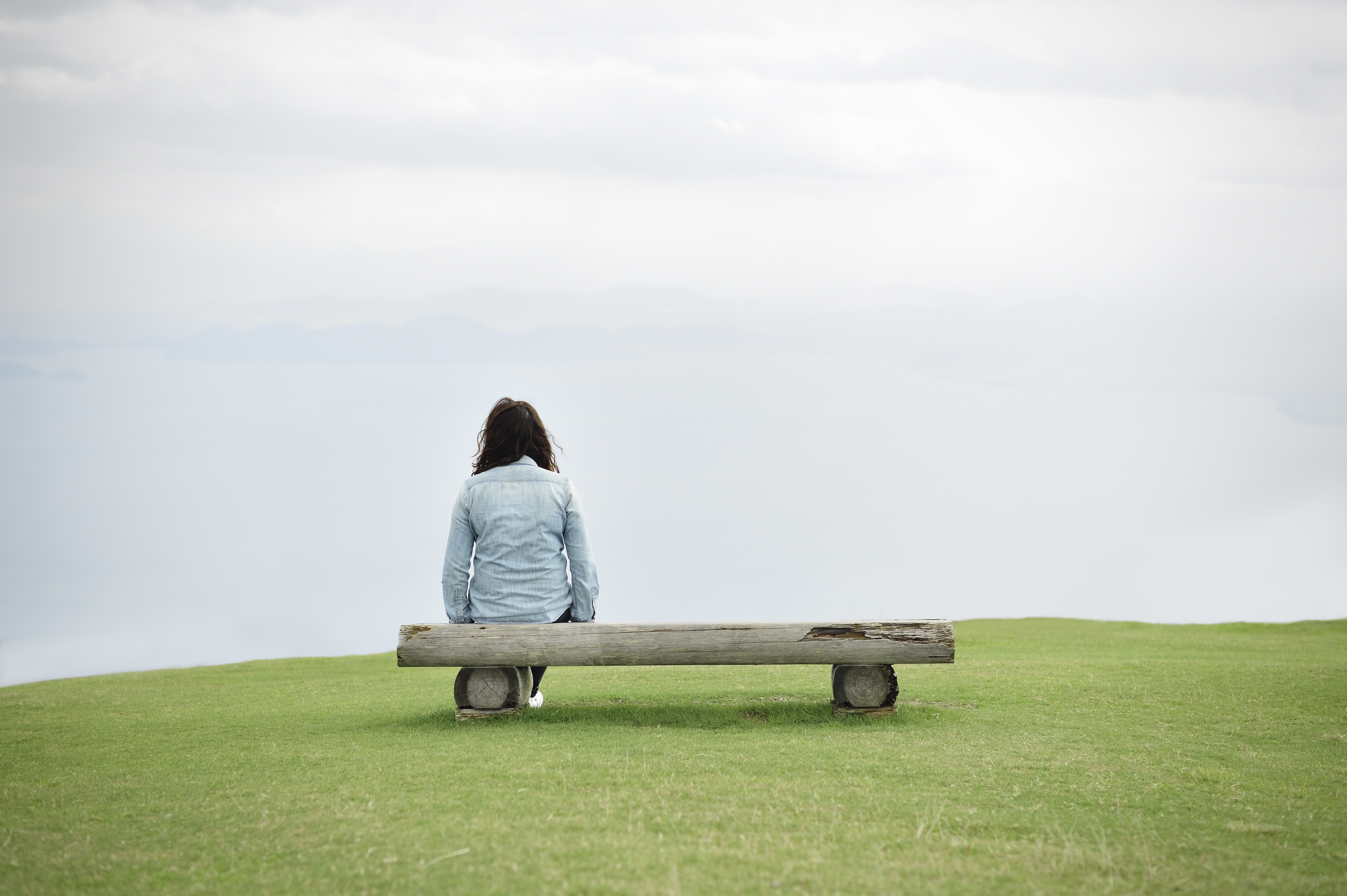 woman-sitting-bench-rear-view