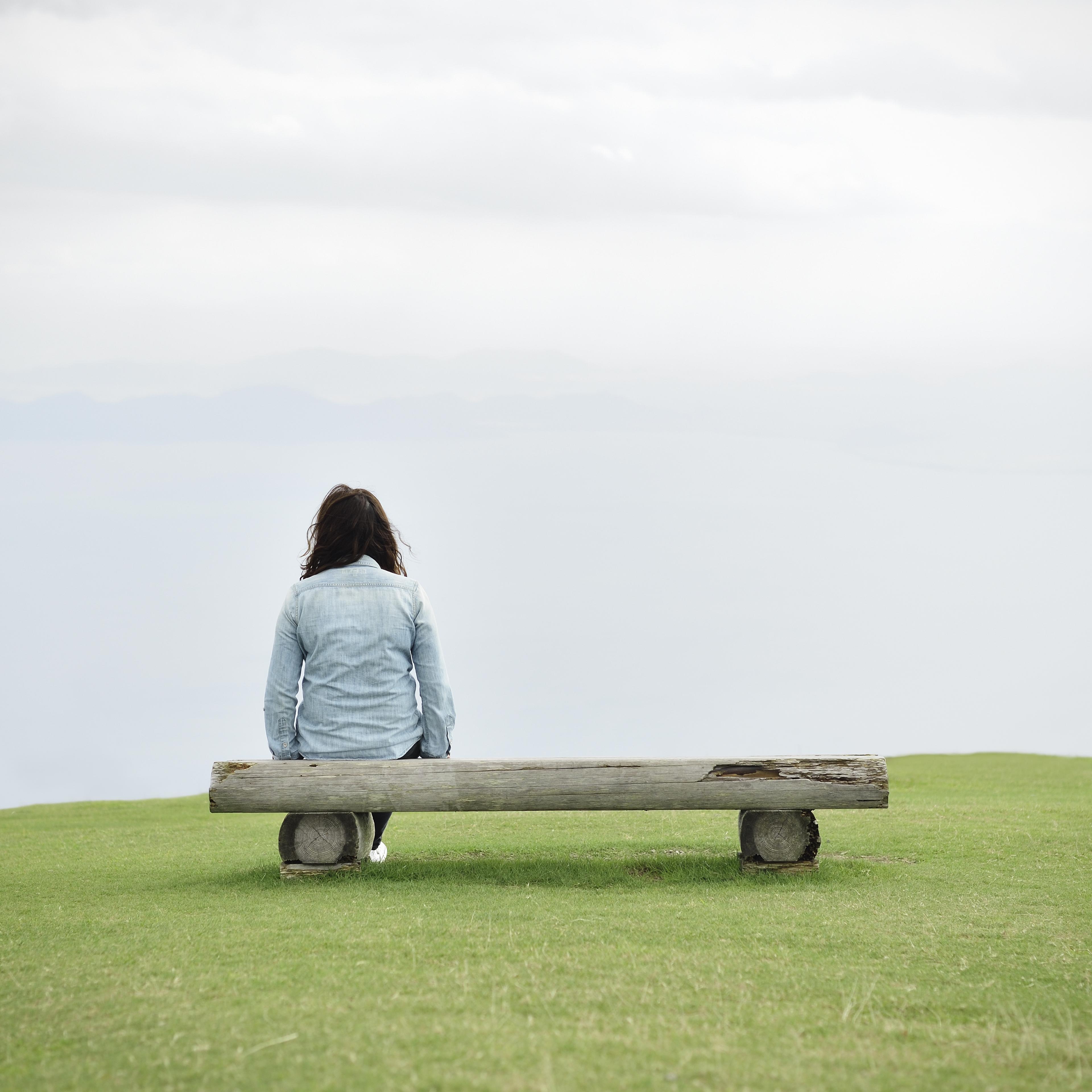 woman-sitting-bench-rear-view