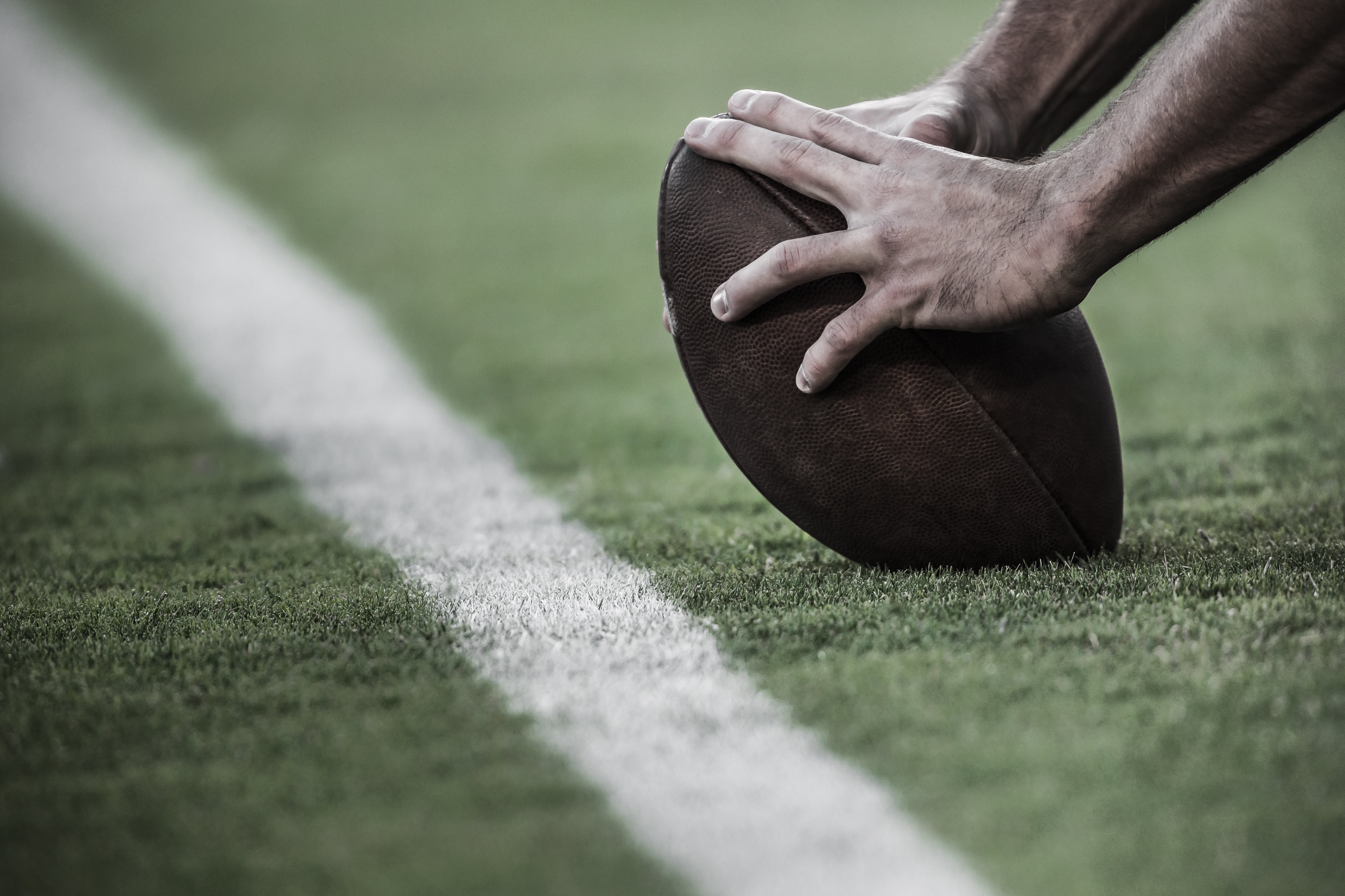 Hands on an American Football