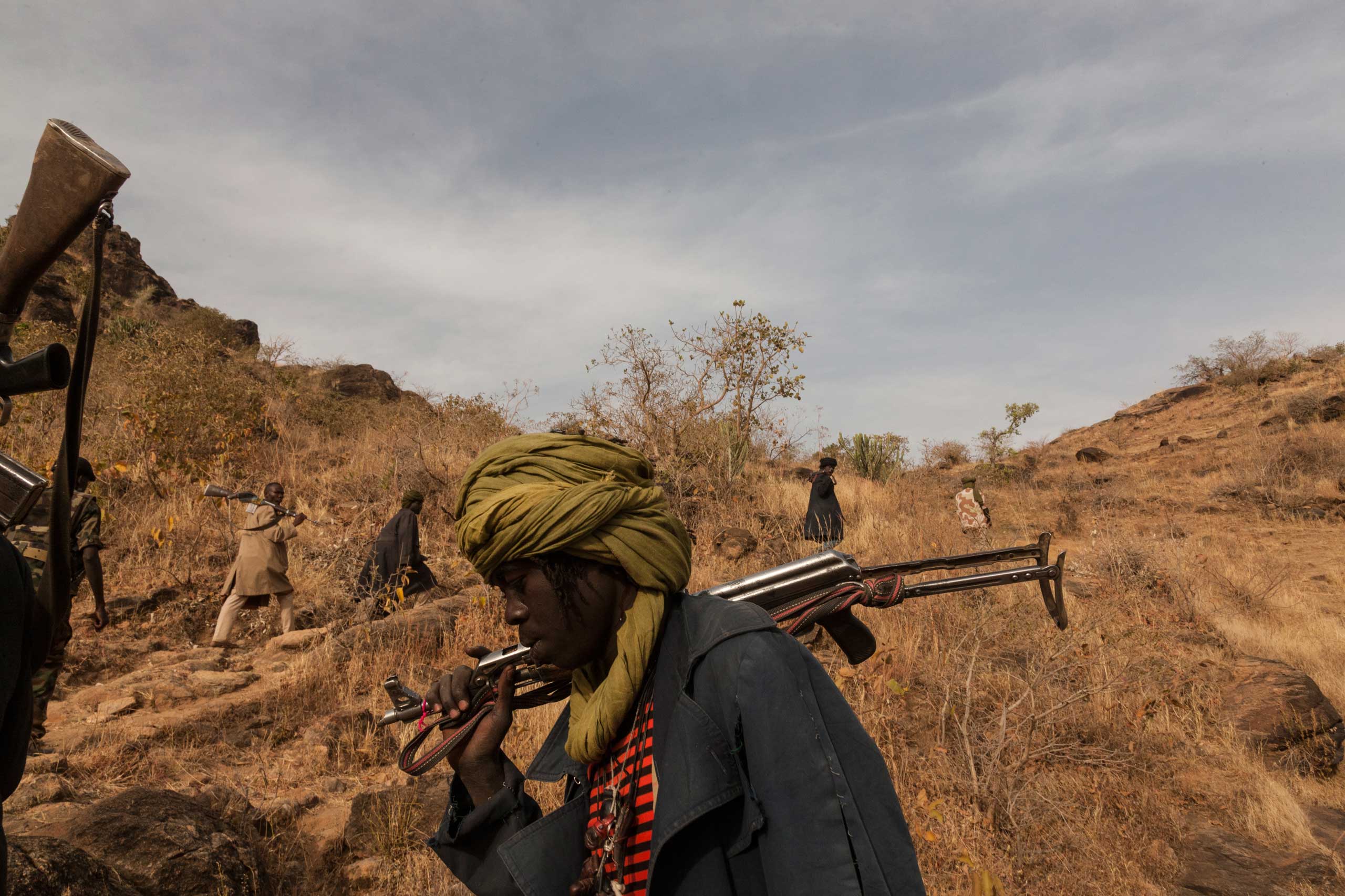 Members of the rebel group Sudan Liberation Army led by Abdul Wahid (SLA-AW) climb towards the front lines in Jebel Marra, Central Darfur, Sudan, on March 4, 2015. The mountainous area has been a stronghold of the SLA-AW since the conflict between the ne