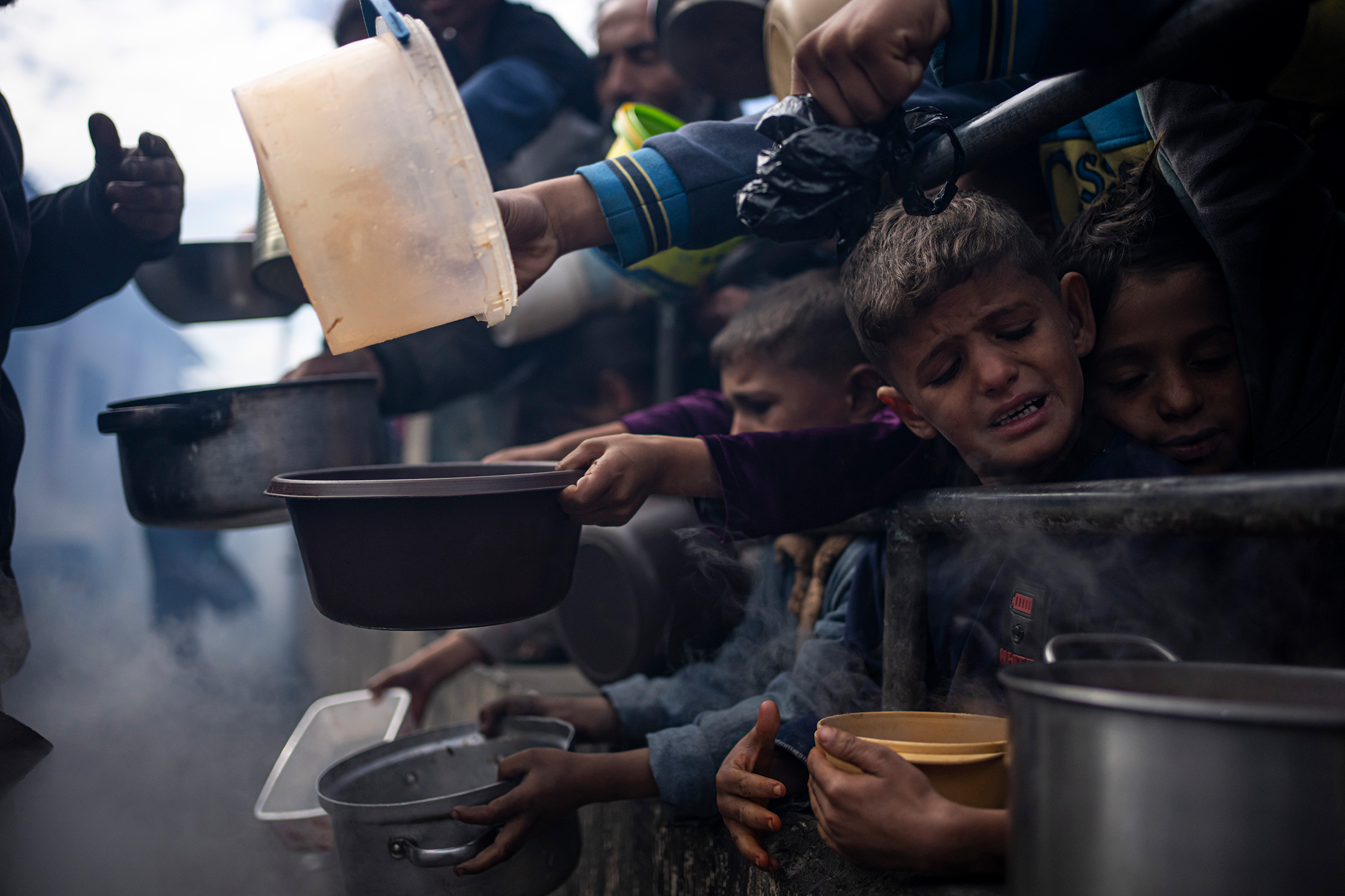 Palestinians line up for a free meal in Rafah, Gaza Strip on Feb. 16, 2024. The World Food Program said Tuesday it has paused deliveries of food to isolated northern Gaza because of increasing chaos across the territory, hiking fears of potential starvat