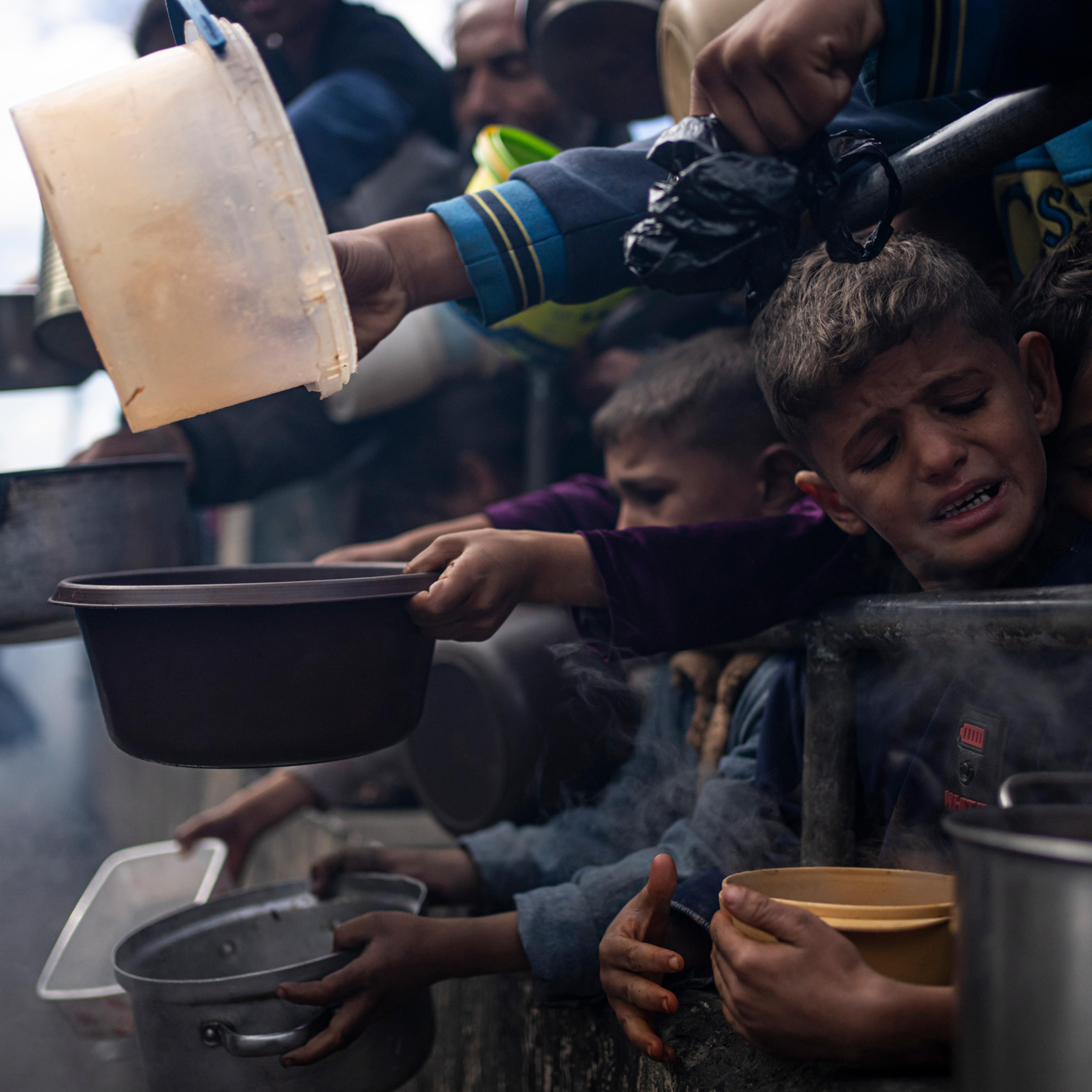 Palestinians line up for a free meal in Rafah, Gaza Strip on Feb. 16, 2024. The World Food Program said Tuesday it has paused deliveries of food to isolated northern Gaza because of increasing chaos across the territory, hiking fears of potential starvat