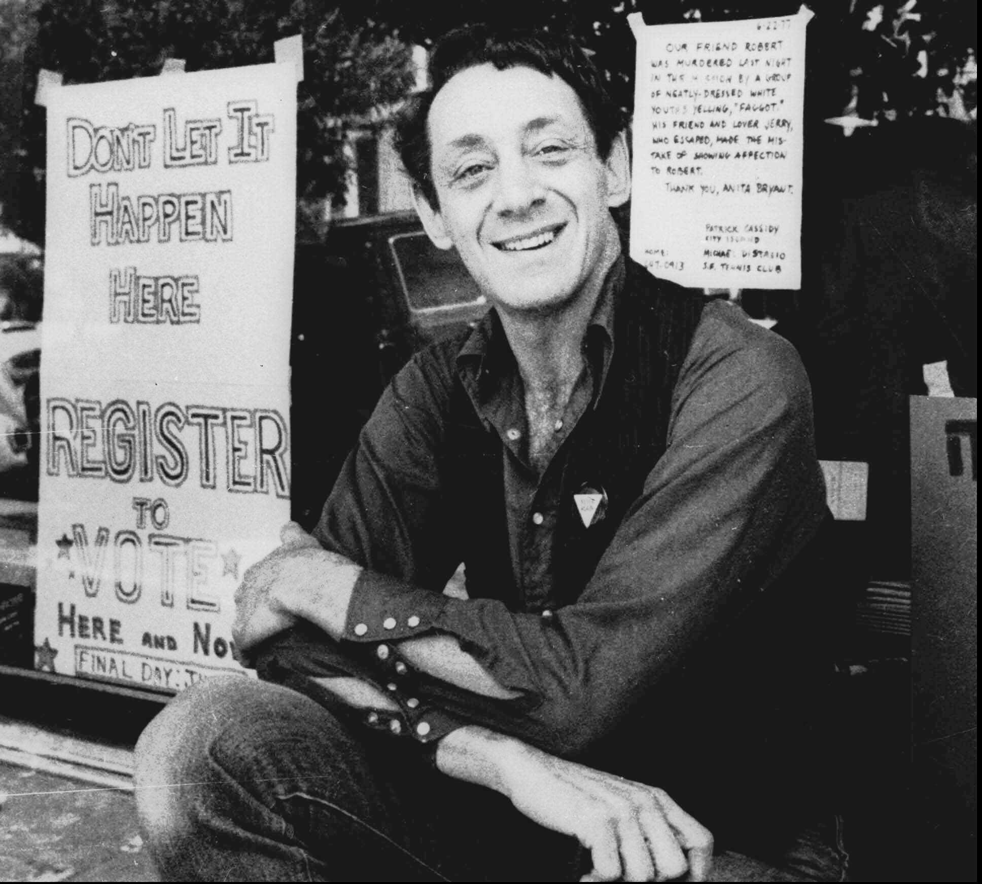 Harvey Milk poses in front of his camera shop in San Francisco on Nov. 9, 1977.