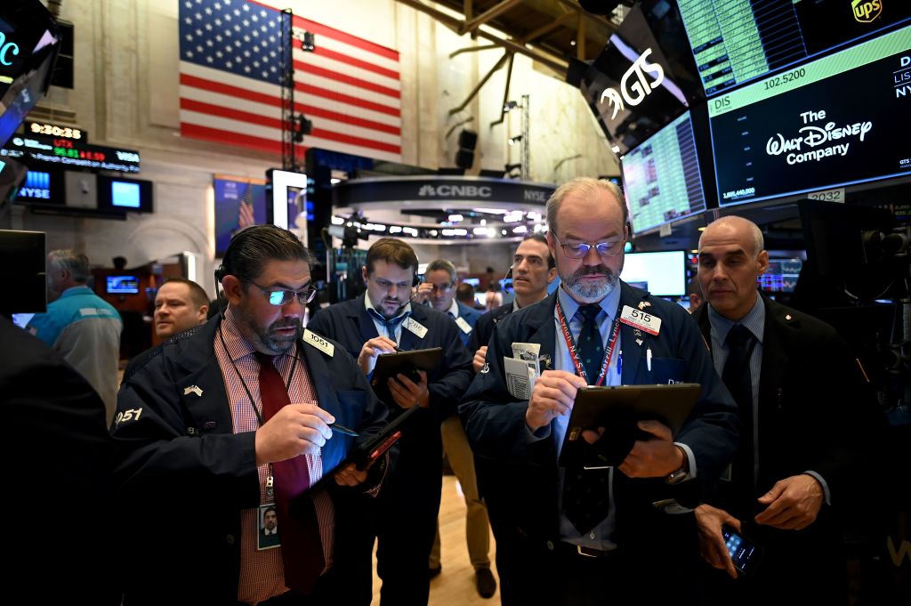 Traders work during the opening bell at the New York Stock Exchange