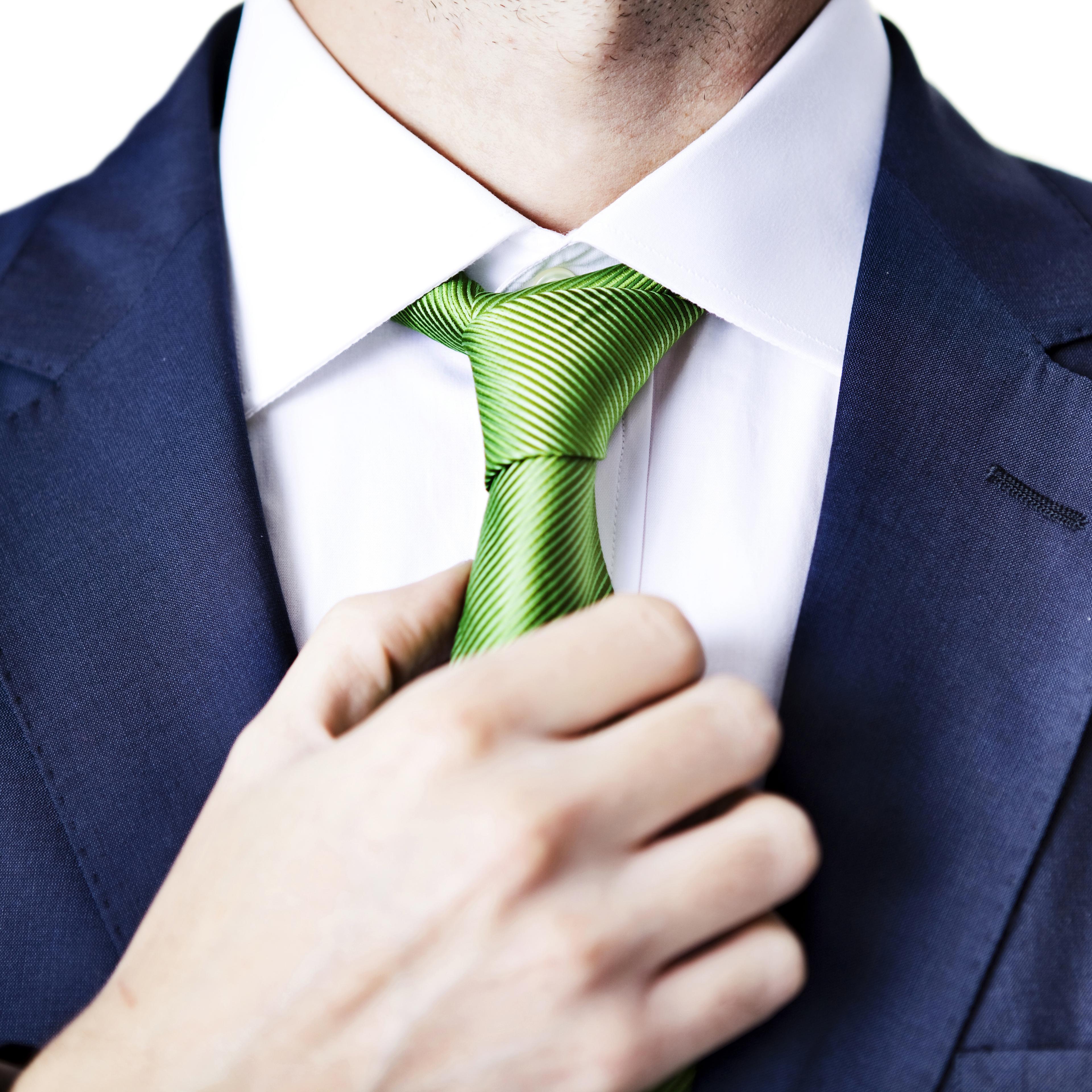 Businessman adjusting tie