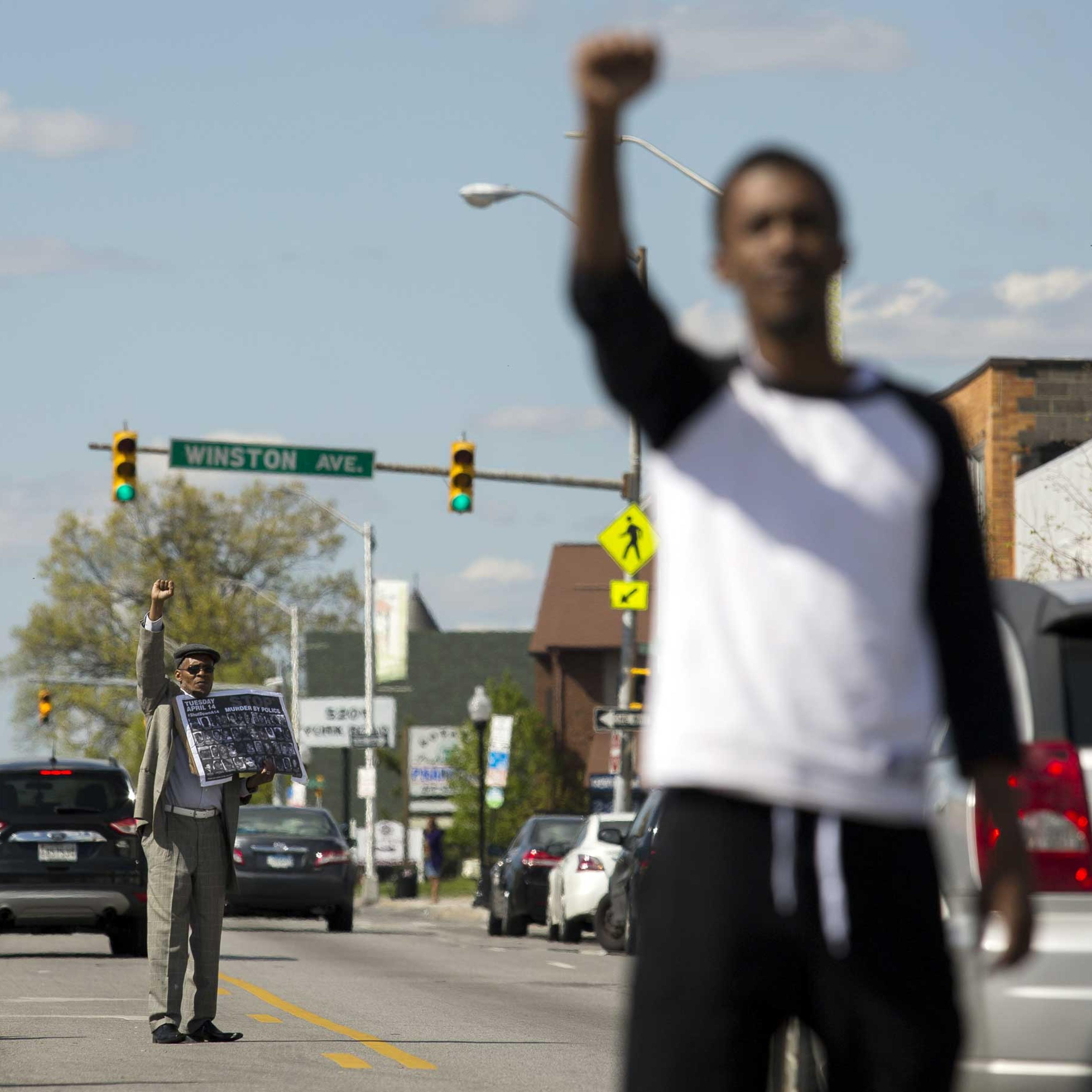 Protestors encourage passing cars to honk while standing in the middle of York Road near Vaughn Greene Funeral Services during the wake of Freddie Gray in Baltimore on April 26, 2015.