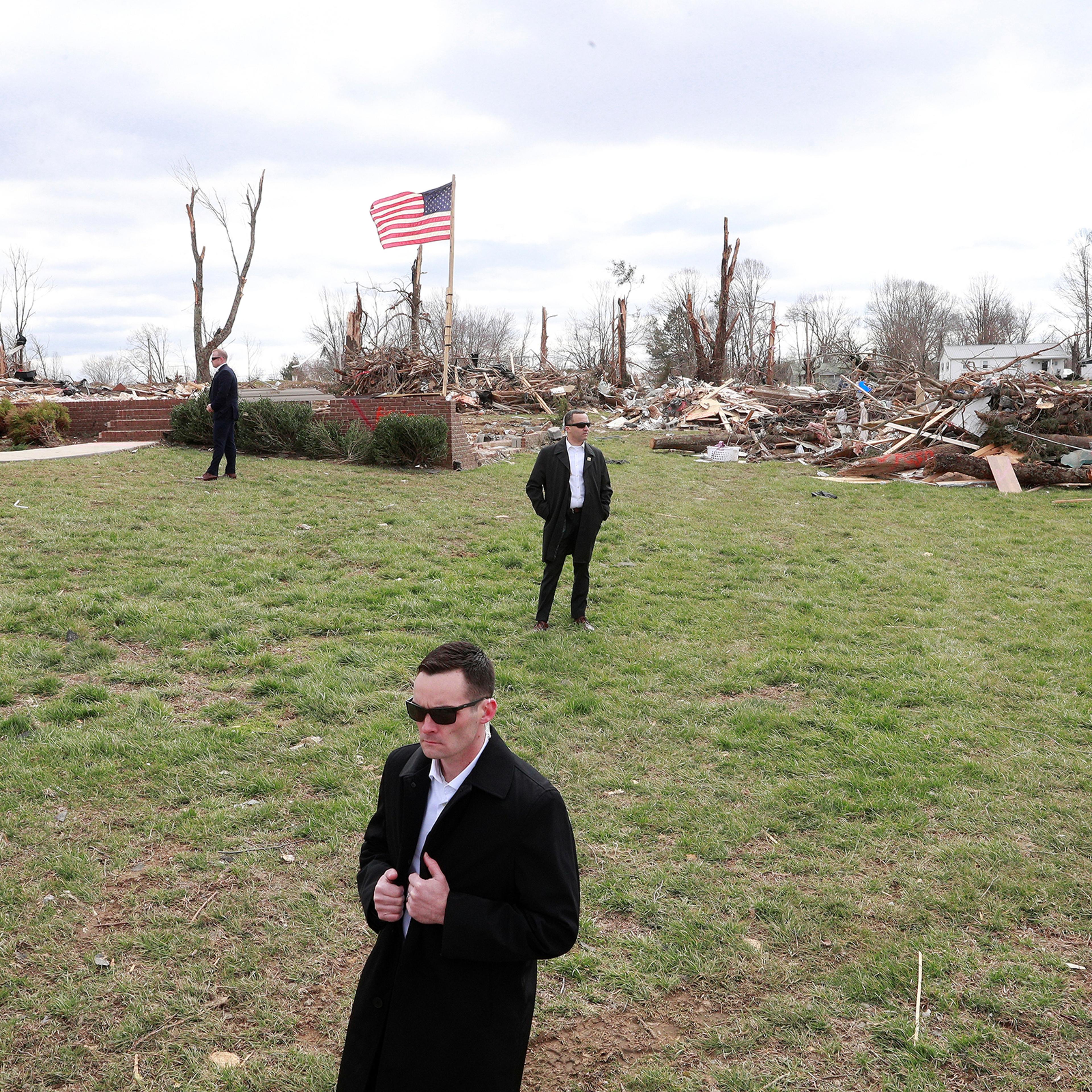 U.S. Secret Service agents stand by as President Trump, not pictured, observes tornado damage in Cookeville, east of Nashville, on March 6, 2020.