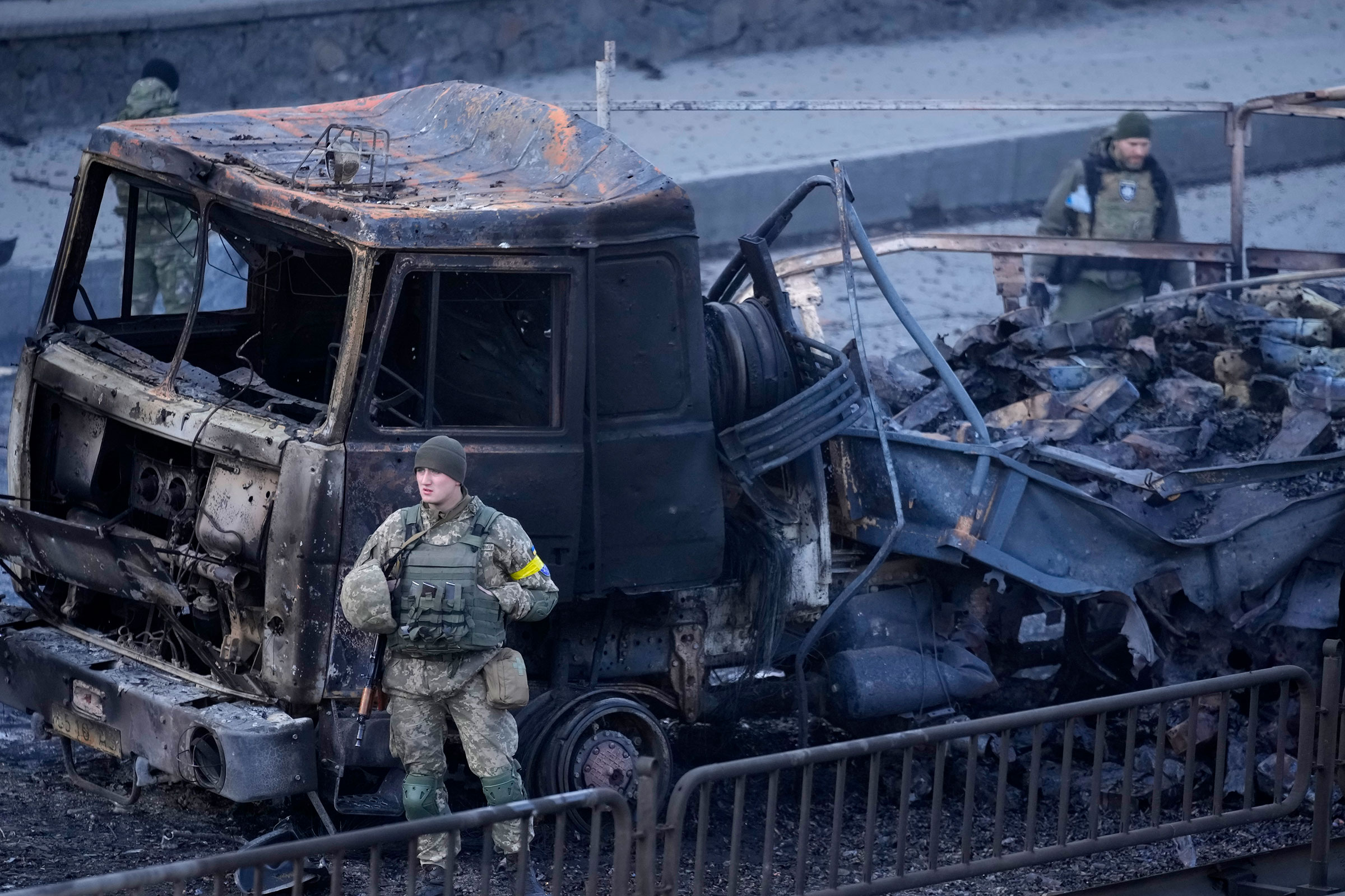 Ukrainian troops inspect the site following a Russian airstrike in Kyiv, Ukraine, on Feb. 26, 2022.