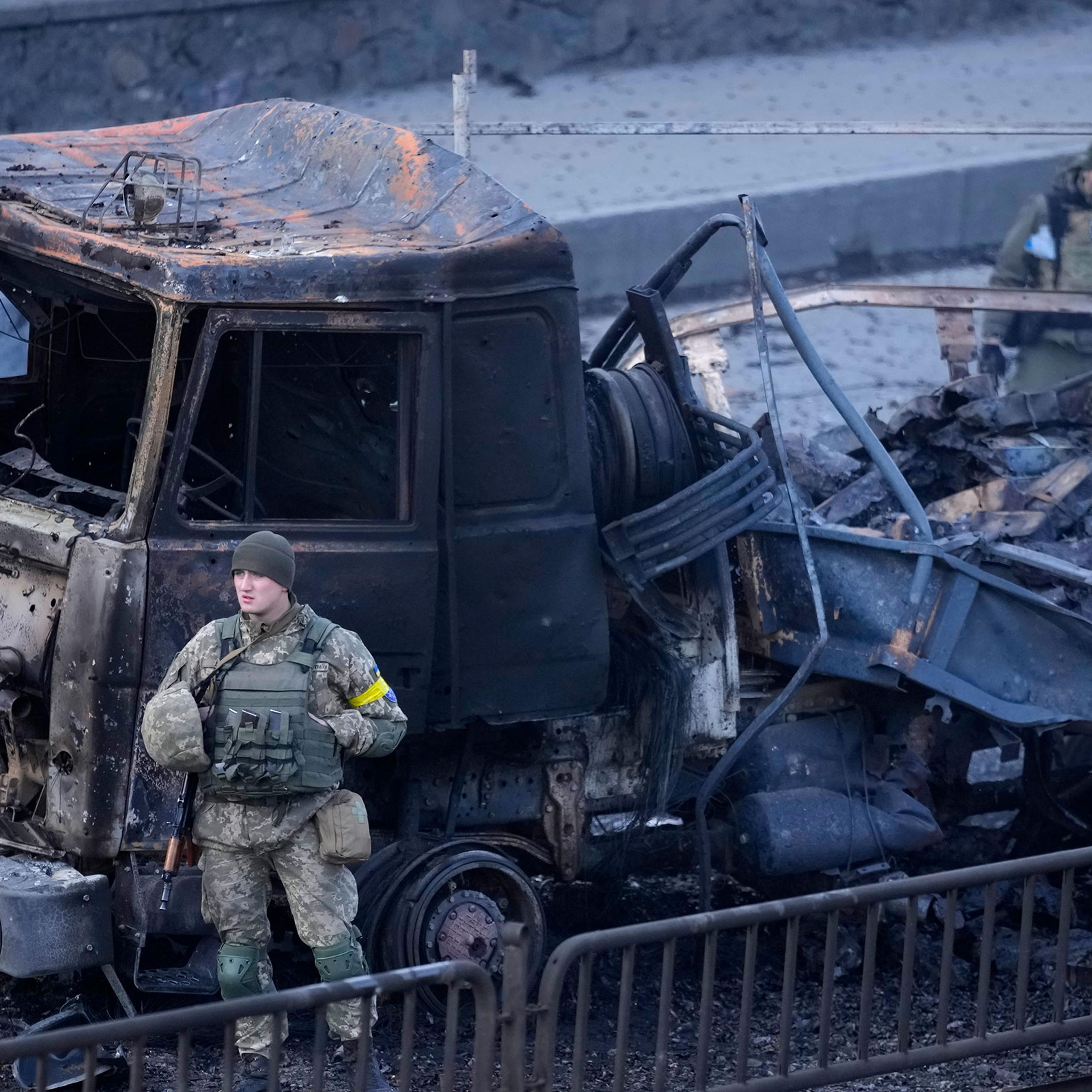 Ukrainian troops inspect the site following a Russian airstrike in Kyiv, Ukraine, on Feb. 26, 2022.
