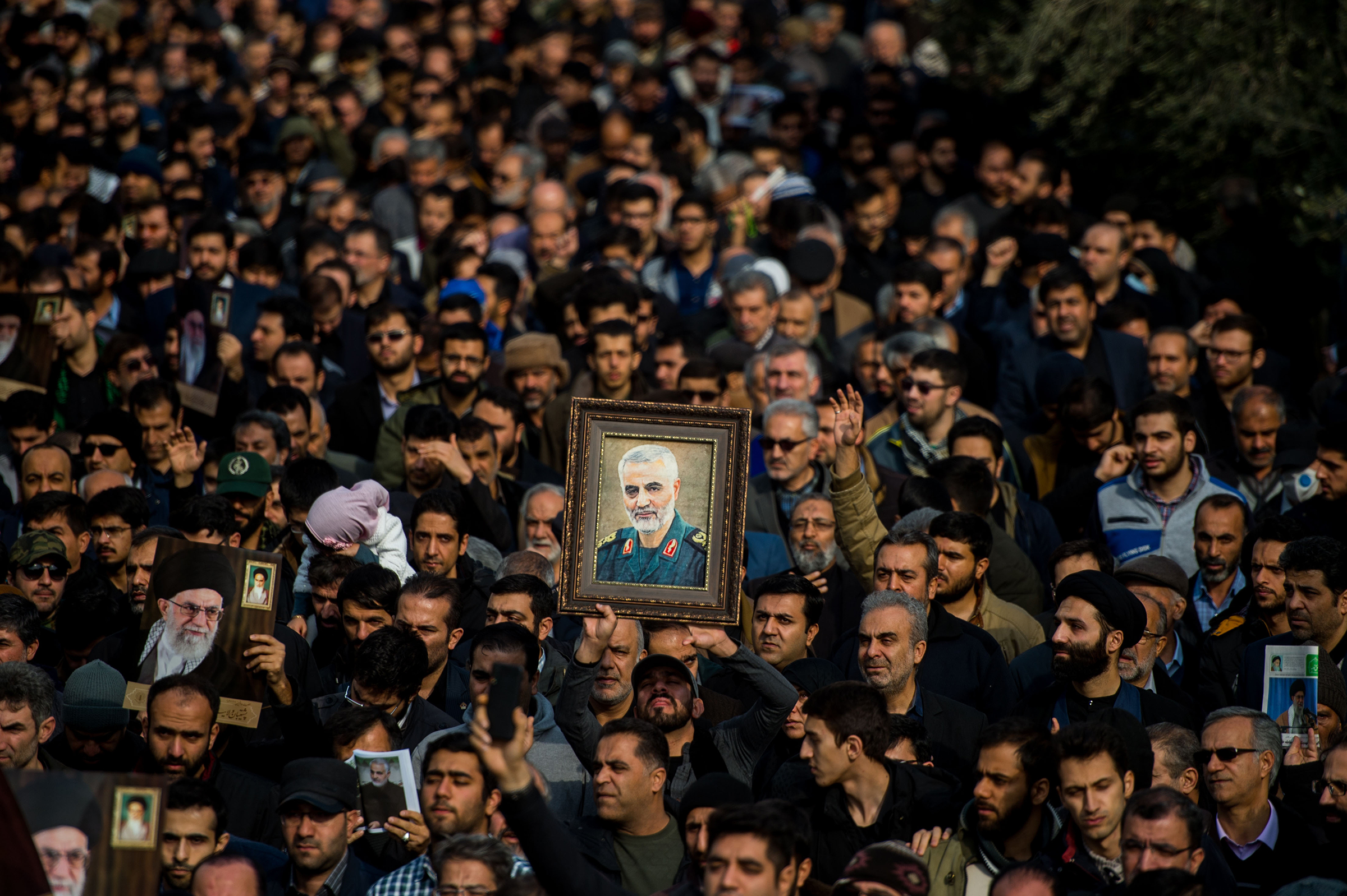 Protesters hold up a framed portrait of Qasem Soleimani, the Iranian commander killed in a U.S. drone strike in Baghdad, during a demonstration in Tehran, Iran, on Jan. 3, 2020.