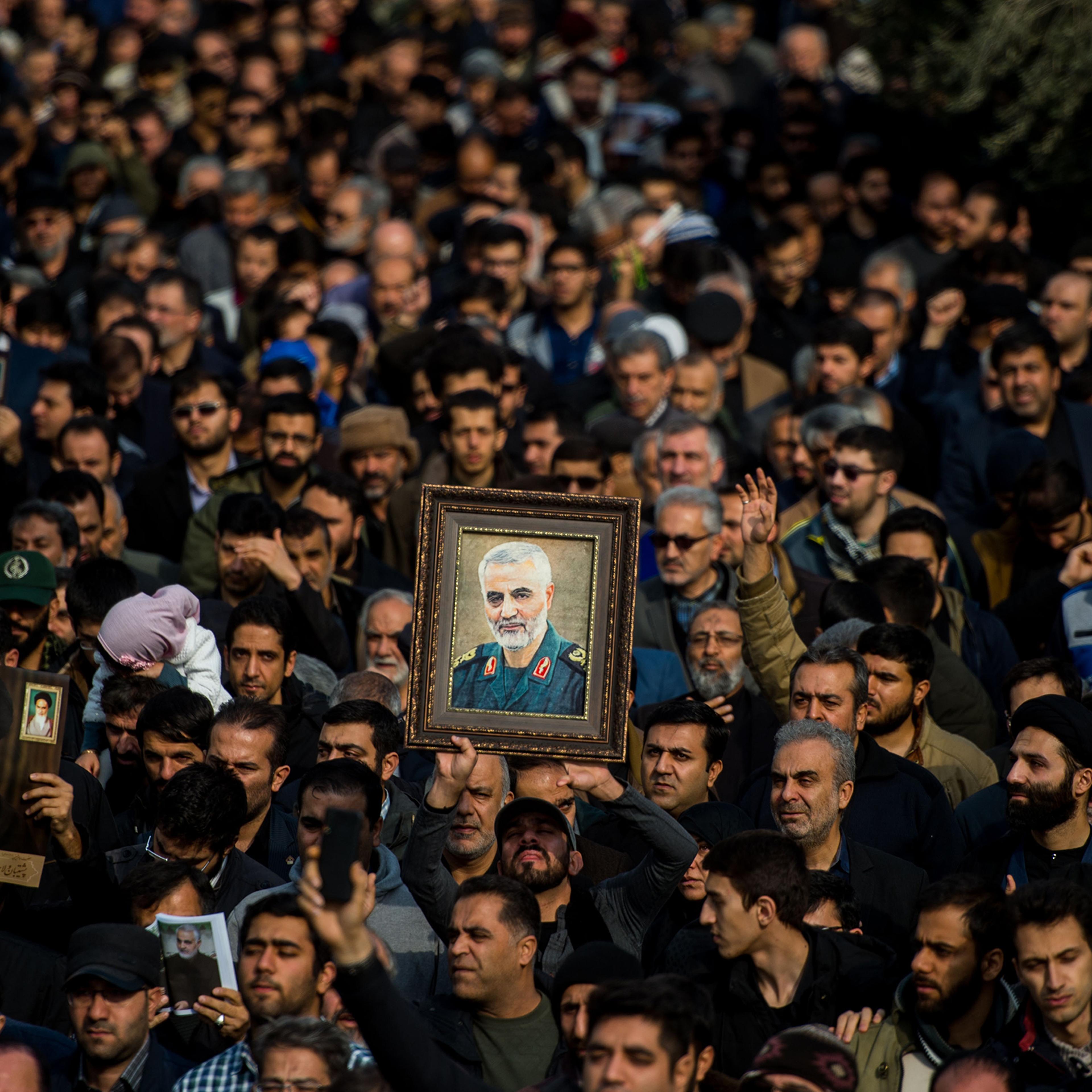 Protesters hold up a framed portrait of Qasem Soleimani, the Iranian commander killed in a U.S. drone strike in Baghdad, during a demonstration in Tehran, Iran, on Jan. 3, 2020.