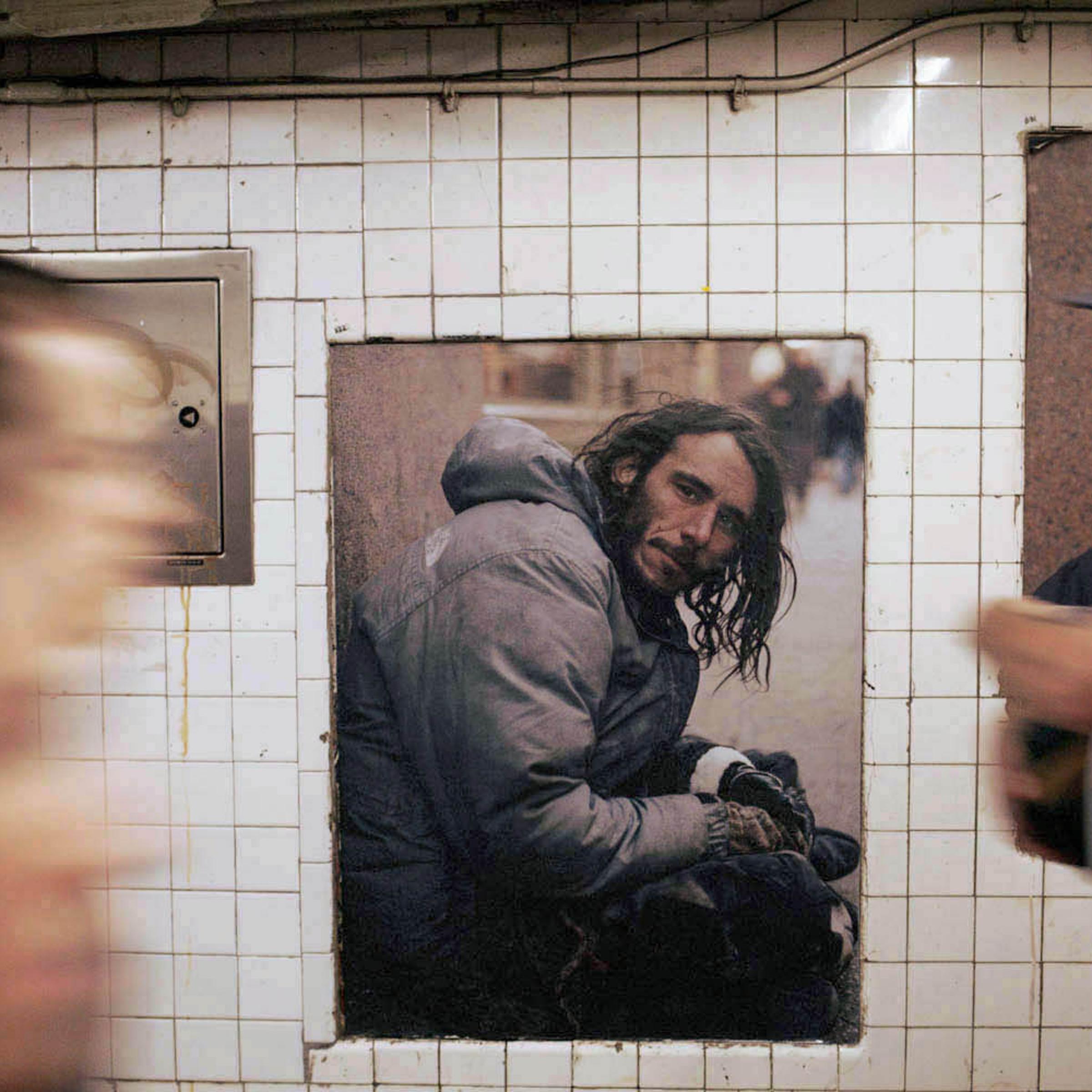 Artist, Andres Serrano's photographic installation, Residents of New York, at the West 4th Street subway station in New York City.